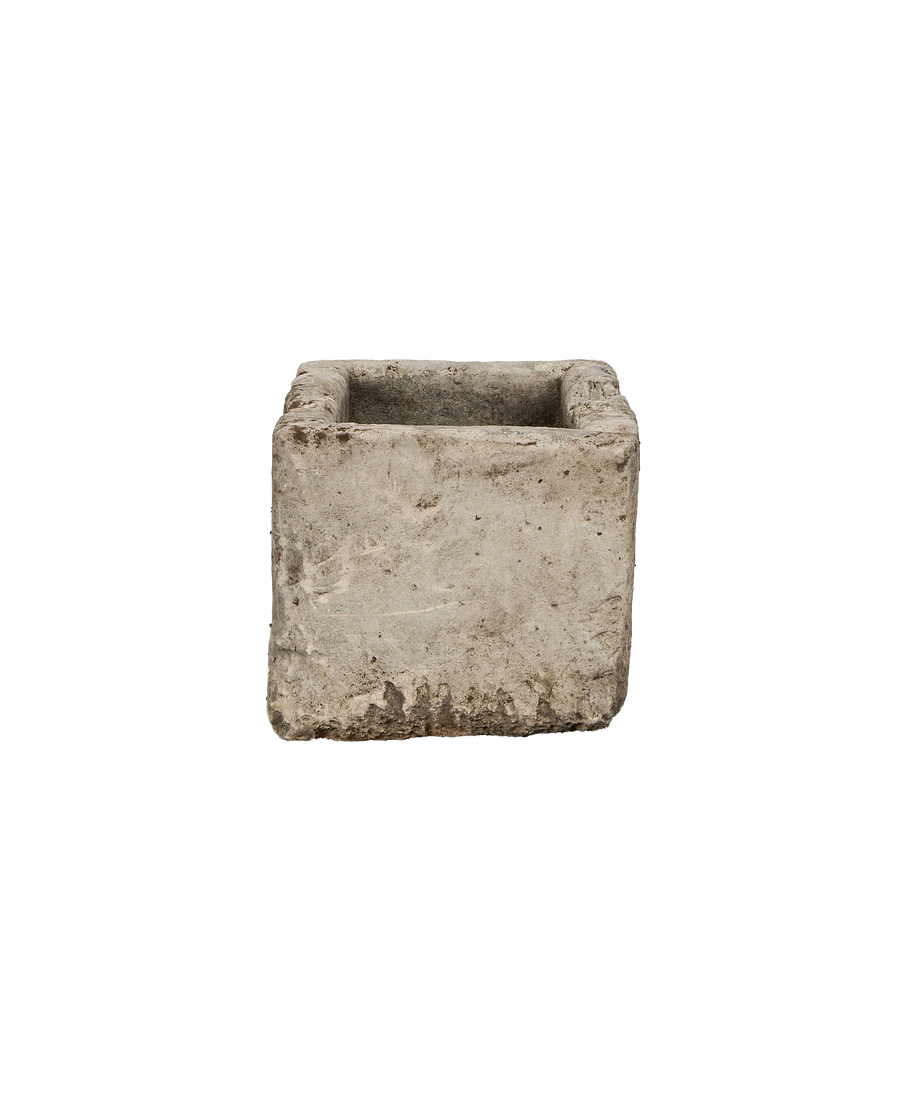 Vintage Indonesian limestone trough closeup, featuring rough texture and weathered antique gray surface.