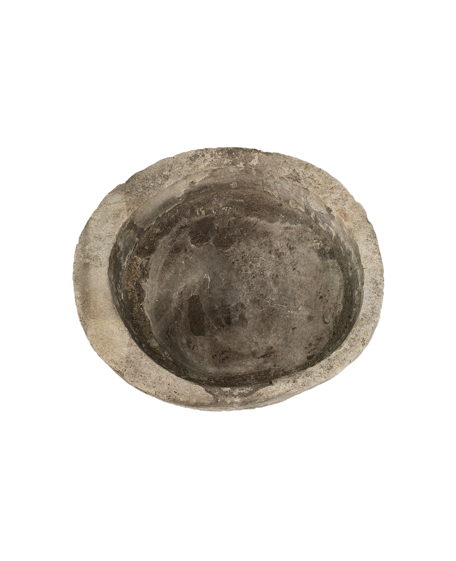 Vintage Indonesian round limestone trough, top-down view showing weathered, textured interior.