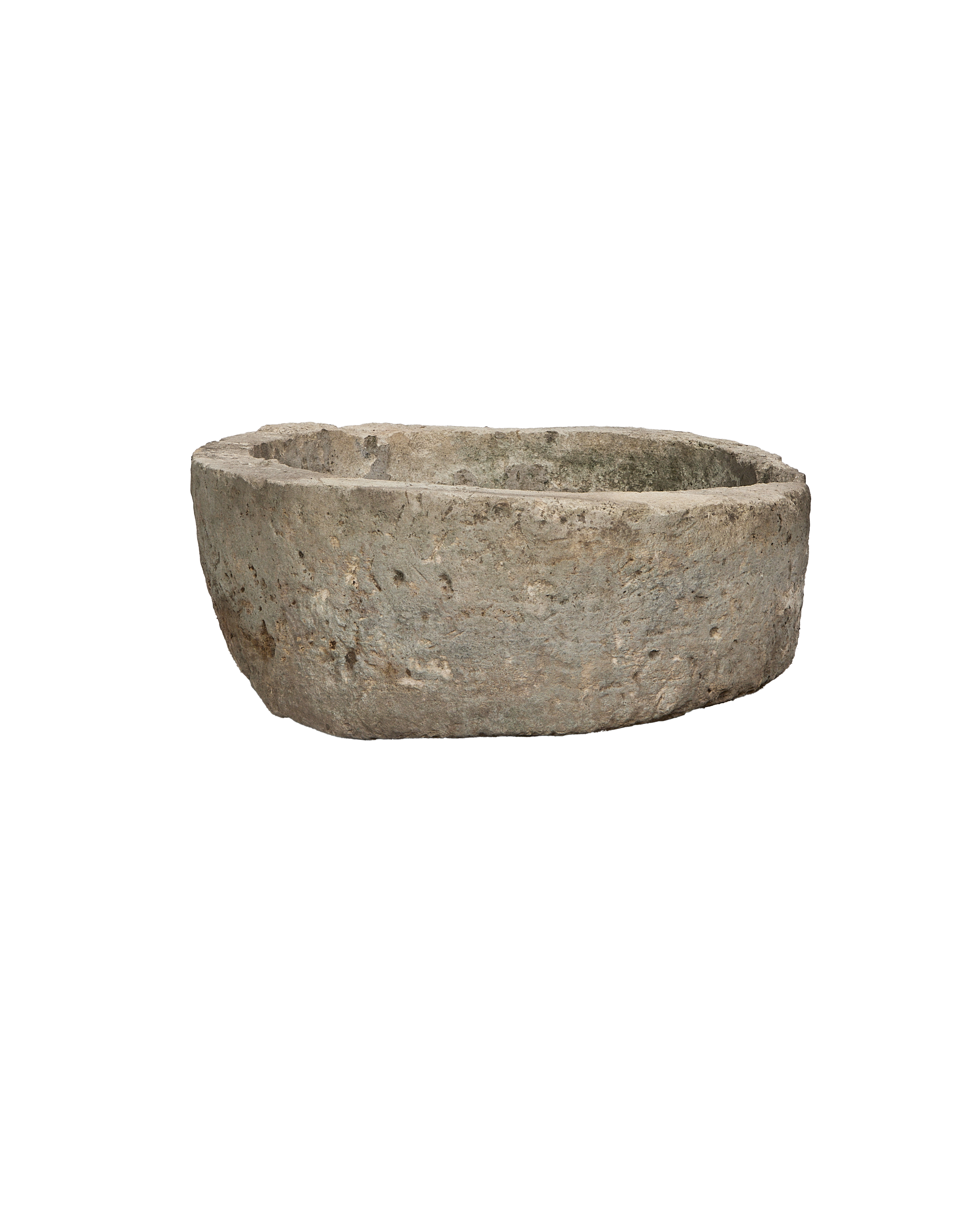 Vintage round Indonesian limestone trough, showing textured natural grey surface from a side view.