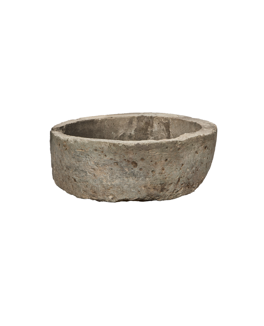 Vintage Indonesian round limestone trough, aged rustic texture from an overhead angle.
