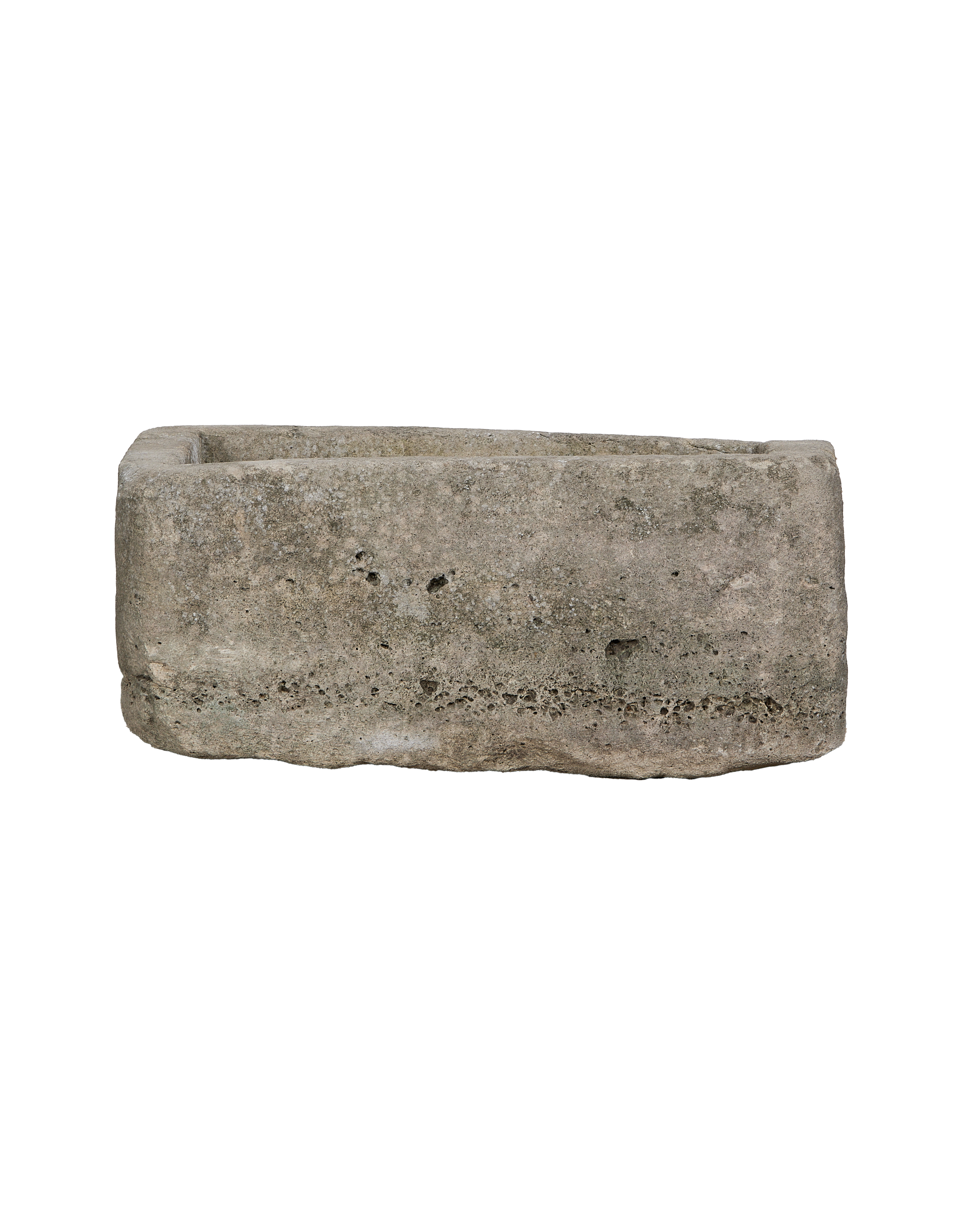 Vintage rectangular limestone trough, side angle, showing the weathered texture and rough-hewn stone.