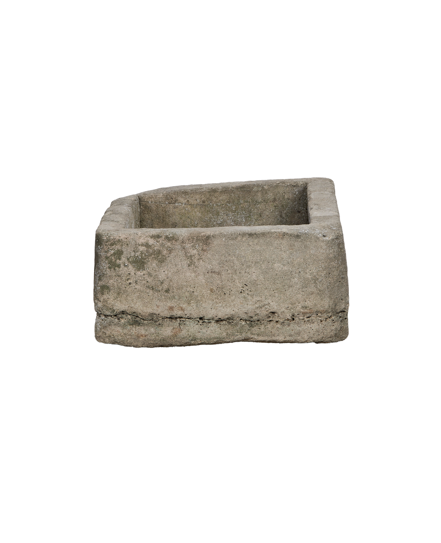 Vintage rectangular limestone trough, showing the side profile with rough texture and green moss patina.