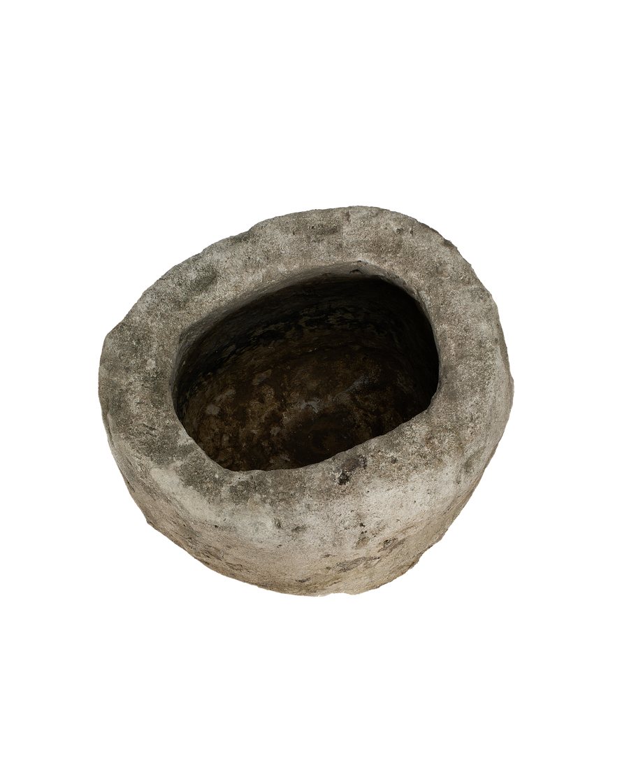 Vintage Indonesian oblong limestone trough, dark weathered interior with rough exterior texture.