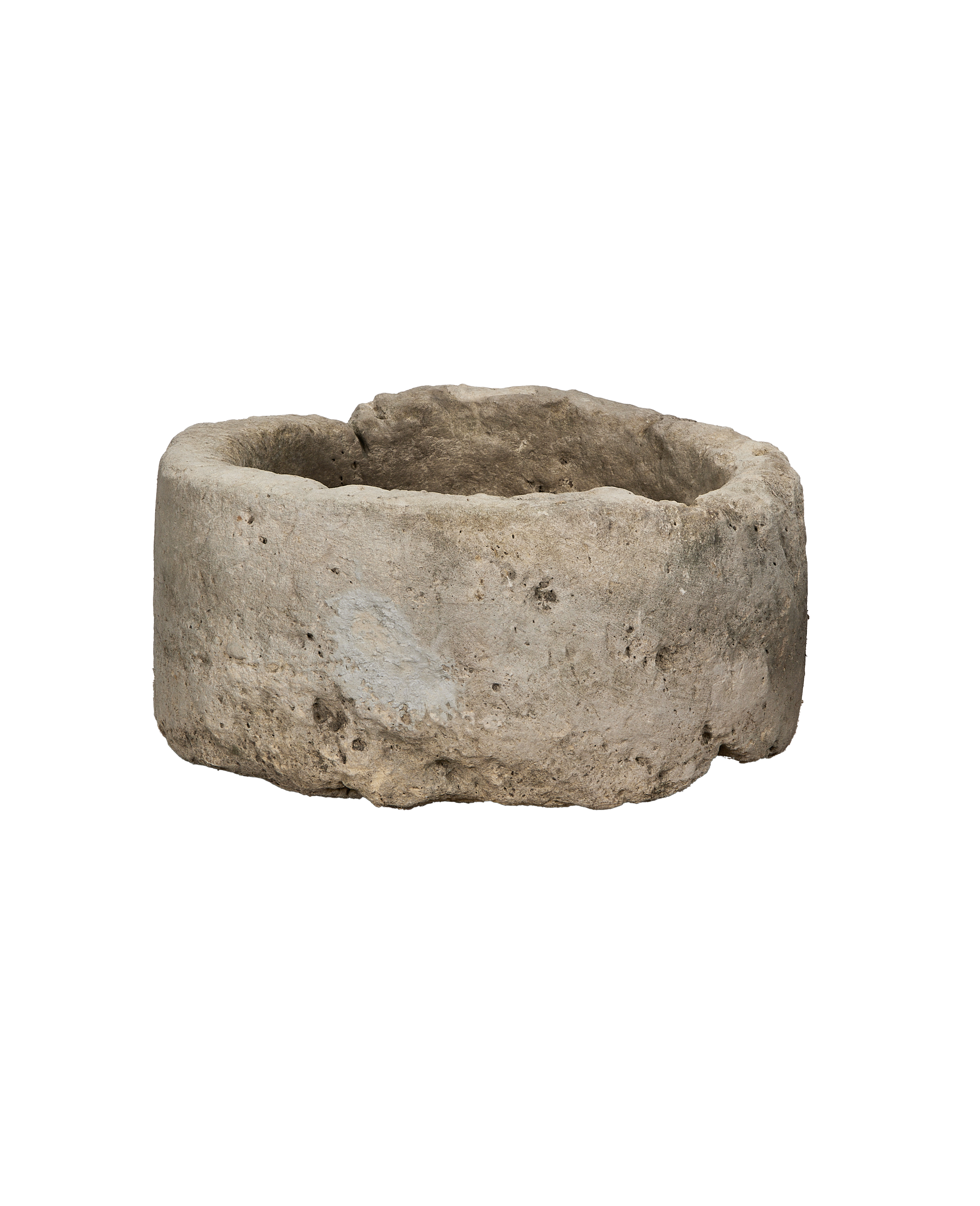 Vintage round limestone trough, side angle view, rustic texture, weathered condition.
