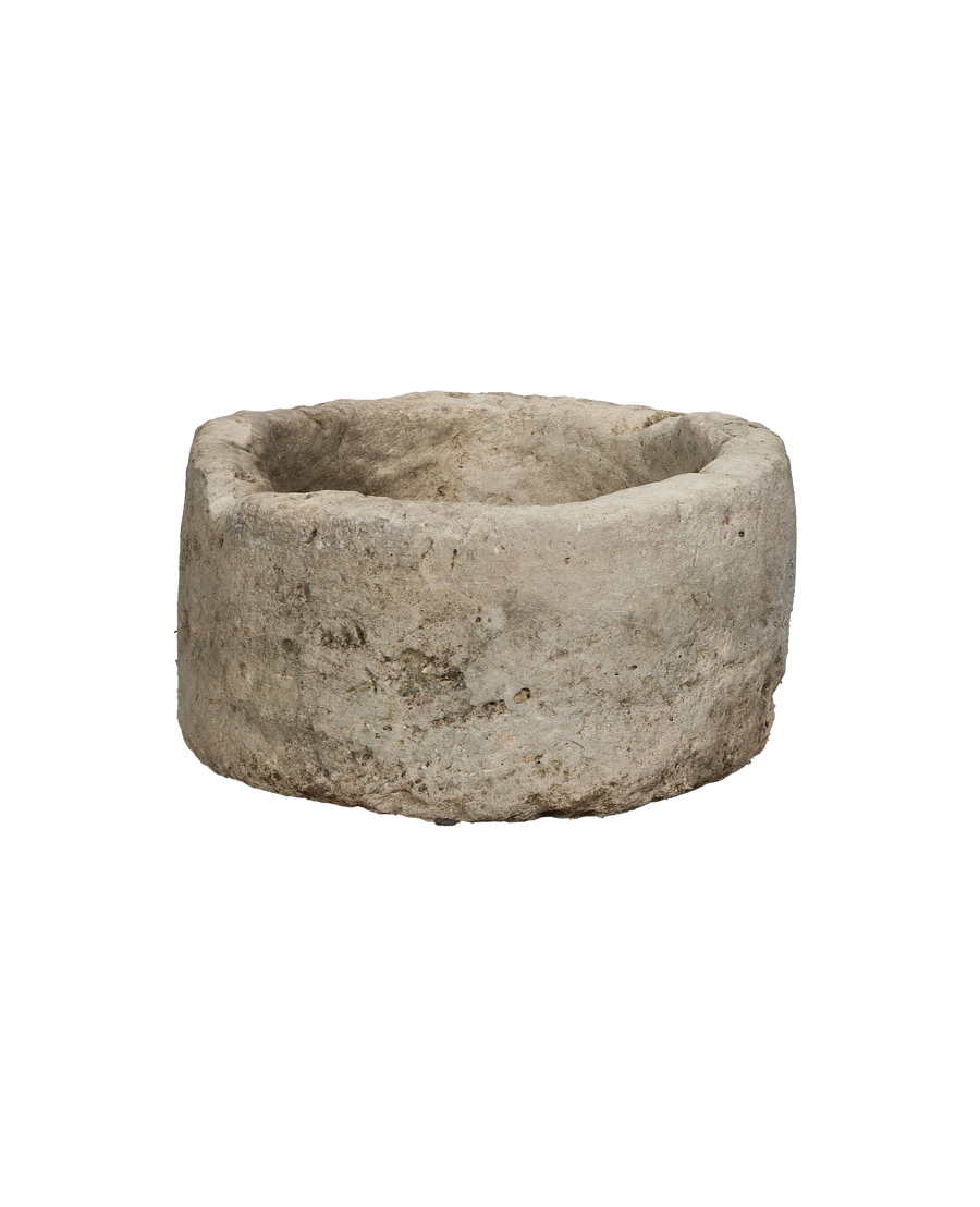 Vintage round Indonesian limestone trough, showing weathered side texture.