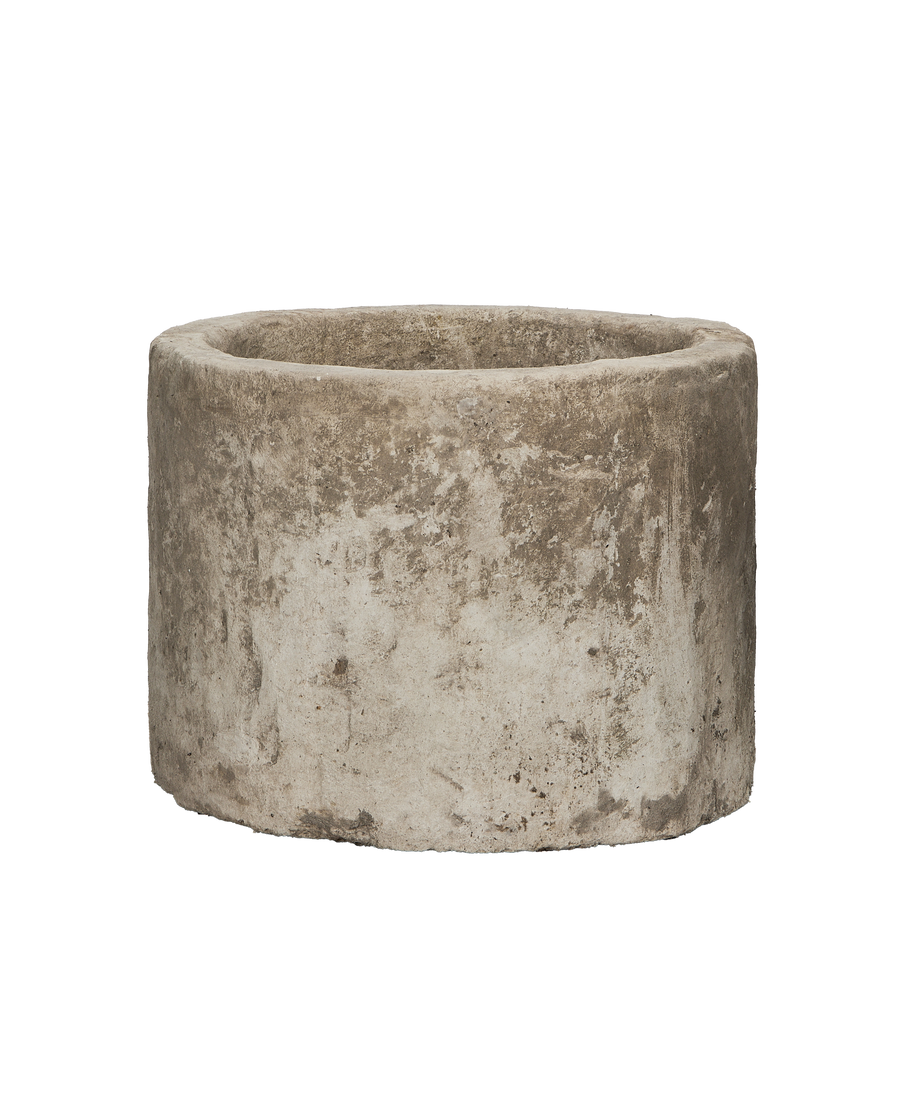 Vintage round Indonesian limestone trough showing weathered, textured surface and top edge.