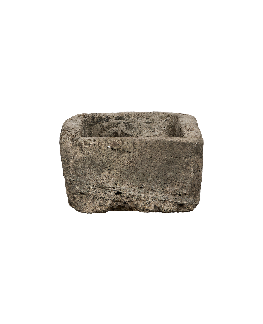 Vintage rectangular limestone trough, showing rough, weathered texture and porous surface detail.