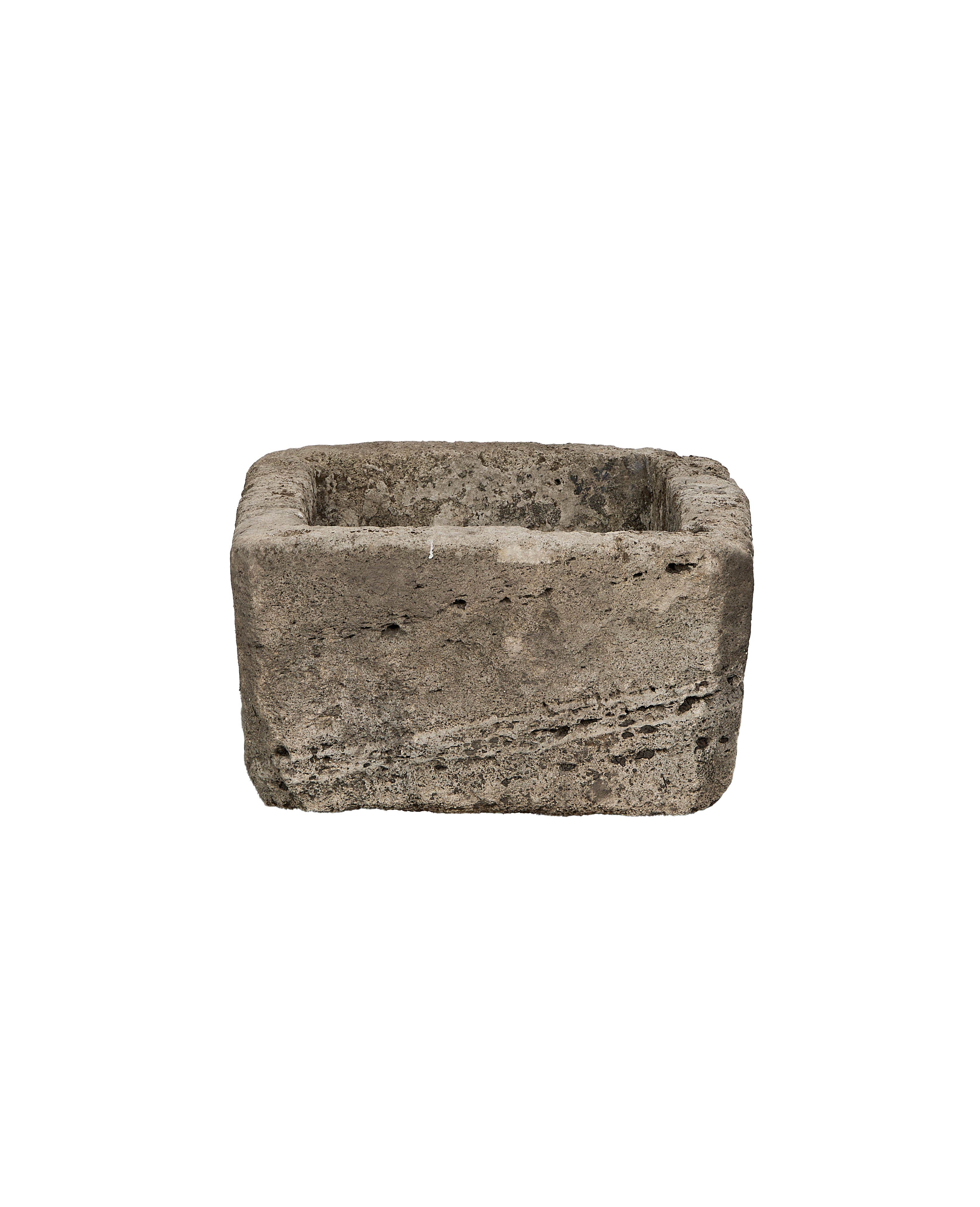 Vintage rectangular limestone trough, showing rough textured exterior and worn interior.
