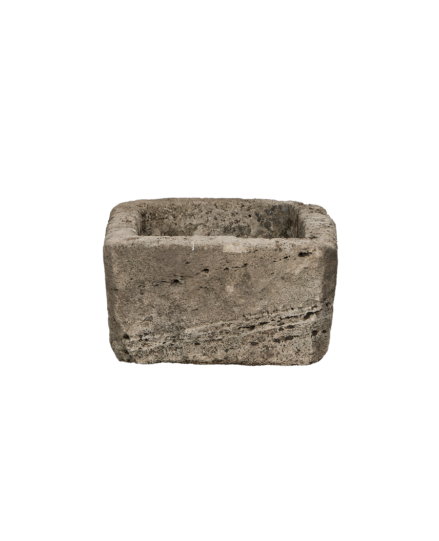 Vintage rectangular limestone trough, showing rough textured exterior and worn interior.