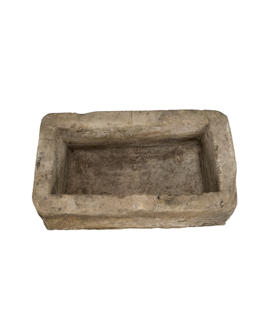 Top-down view of a rectangular vintage Indonesian limestone trough with weathered texture.