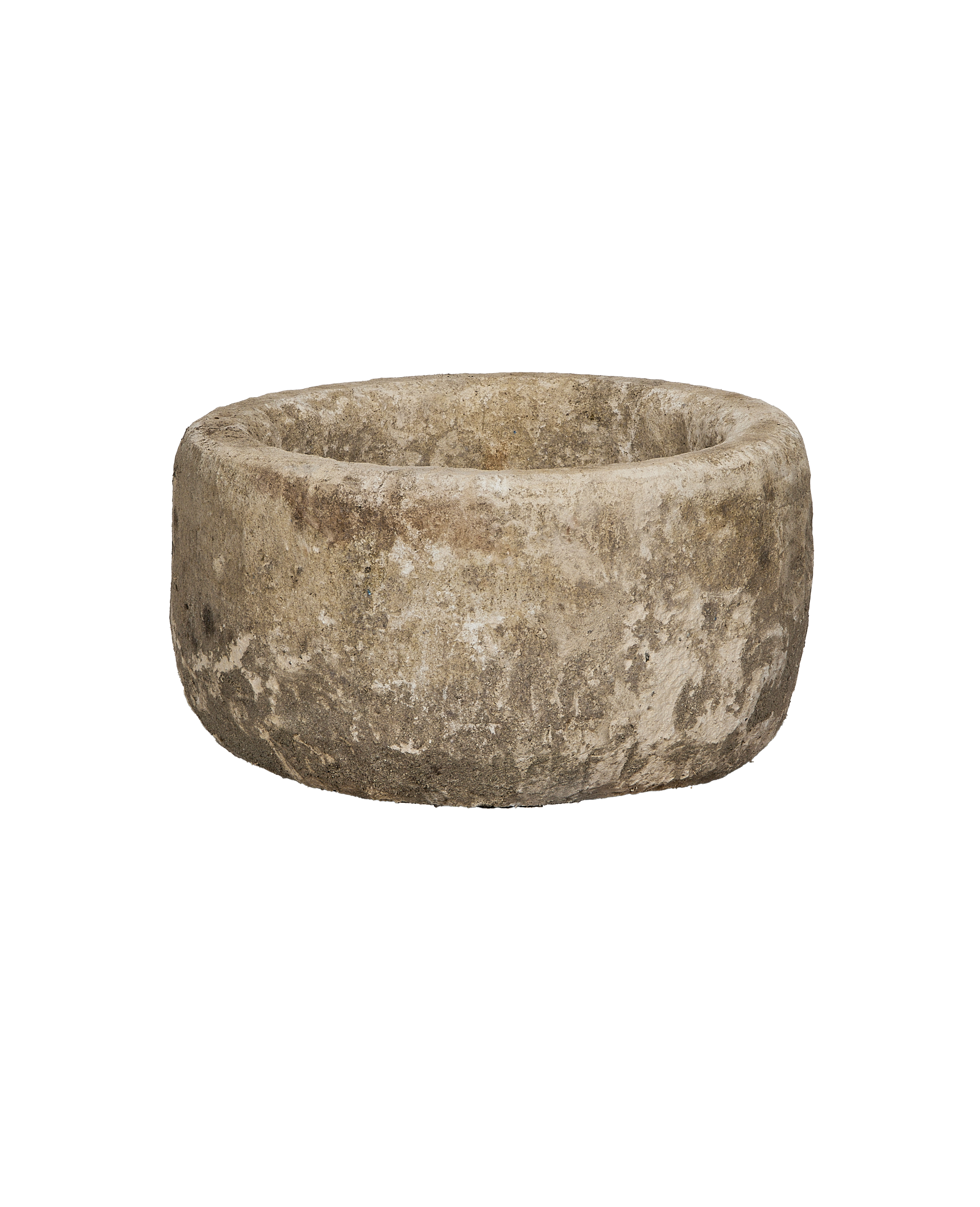 Vintage Indonesian round limestone trough, showing weathered texture from a slightly elevated side view.
