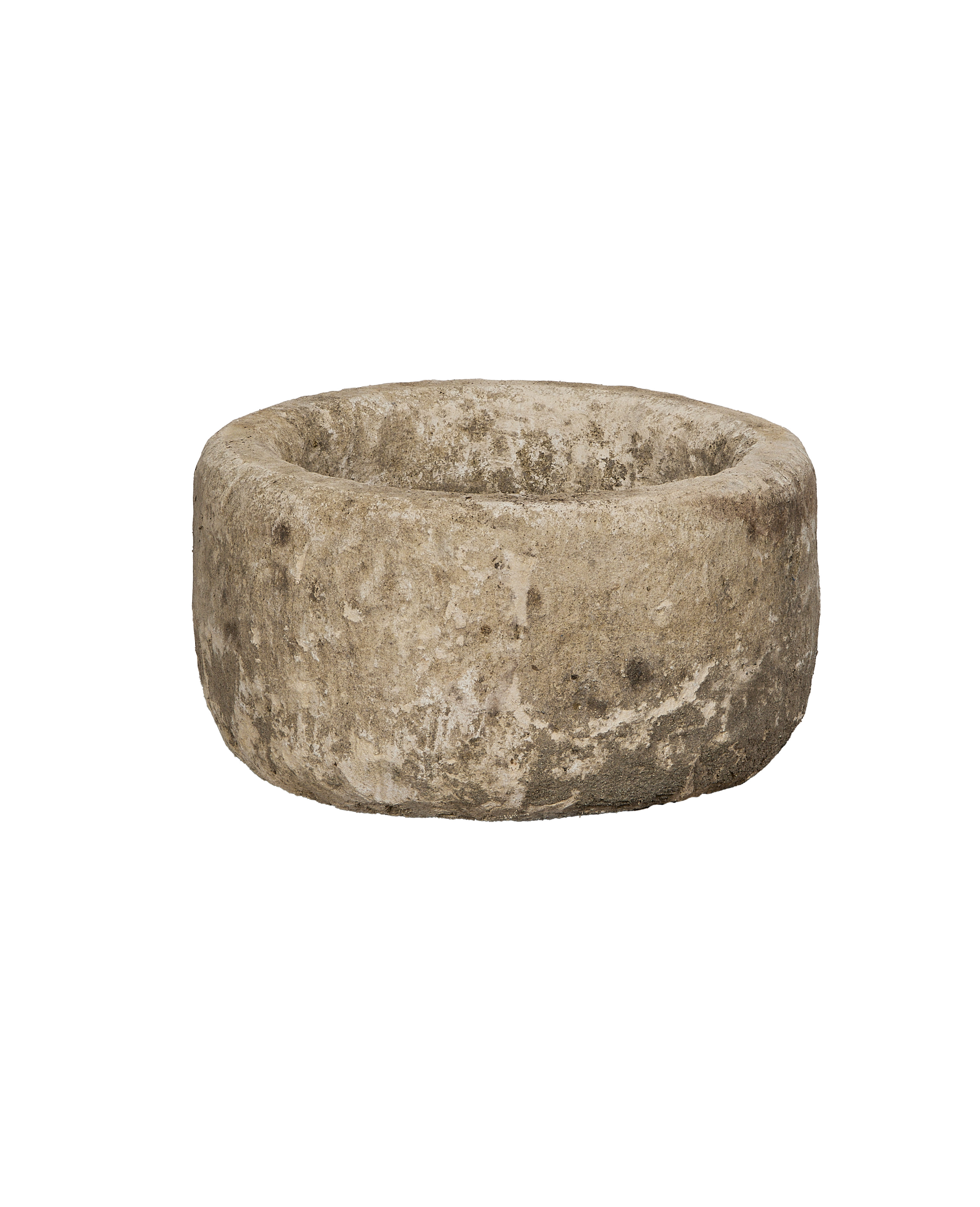 Vintage round Indonesian limestone trough from a lower angle, highlighting its weathered, uneven texture.