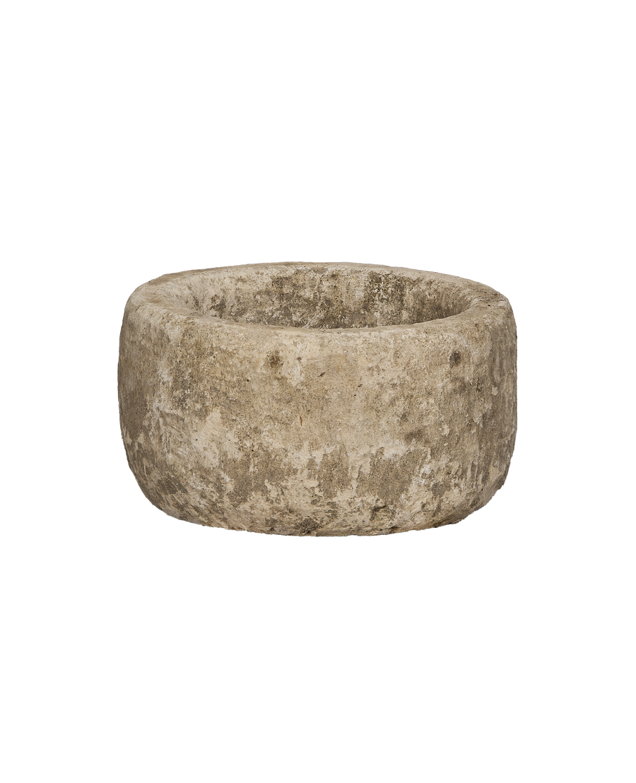 Vintage Indonesian round limestone trough, showing weathered texture from an elevated angle.