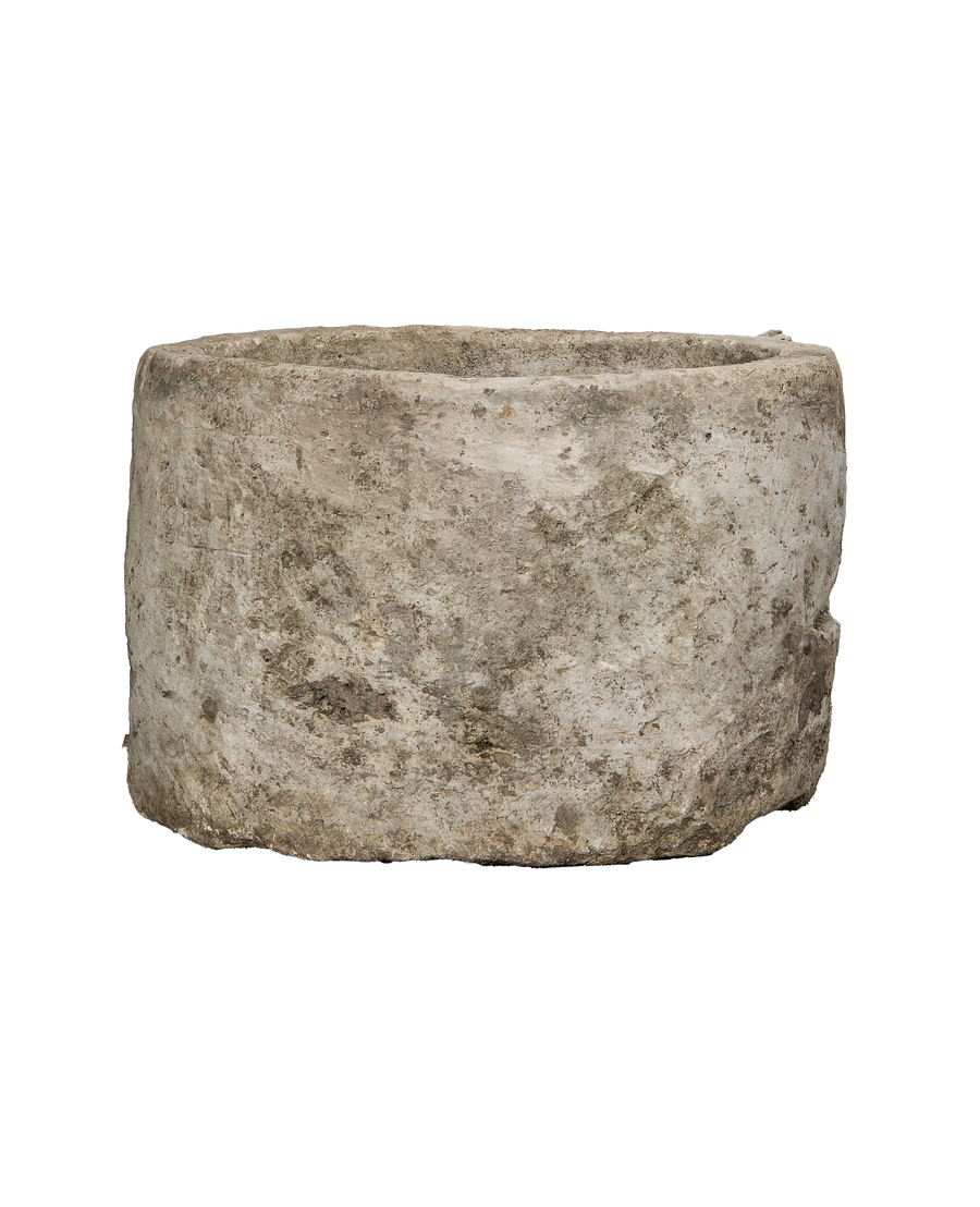 Vintage oblong Indonesian limestone trough, OAK, with textured, weathered exterior from wide side angle.
