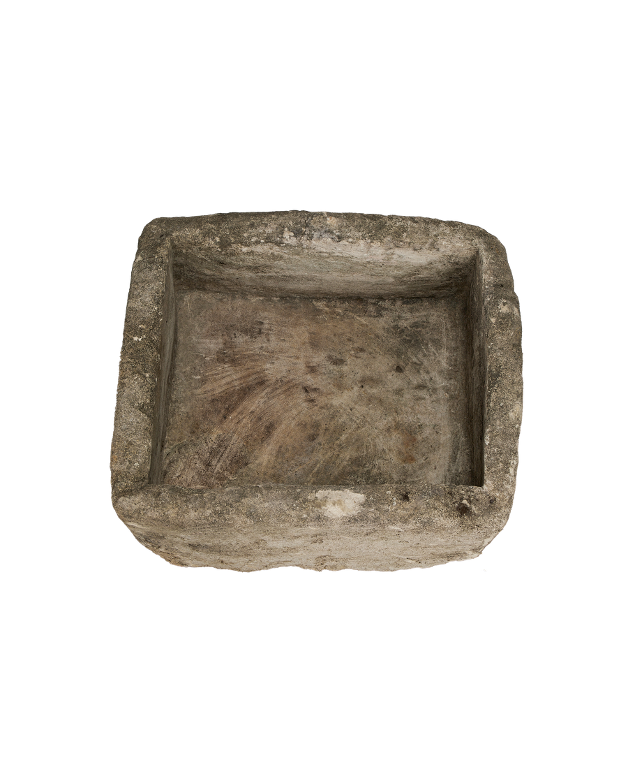 Vintage square limestone trough, top-down view highlighting weathered texture and shallow interior.