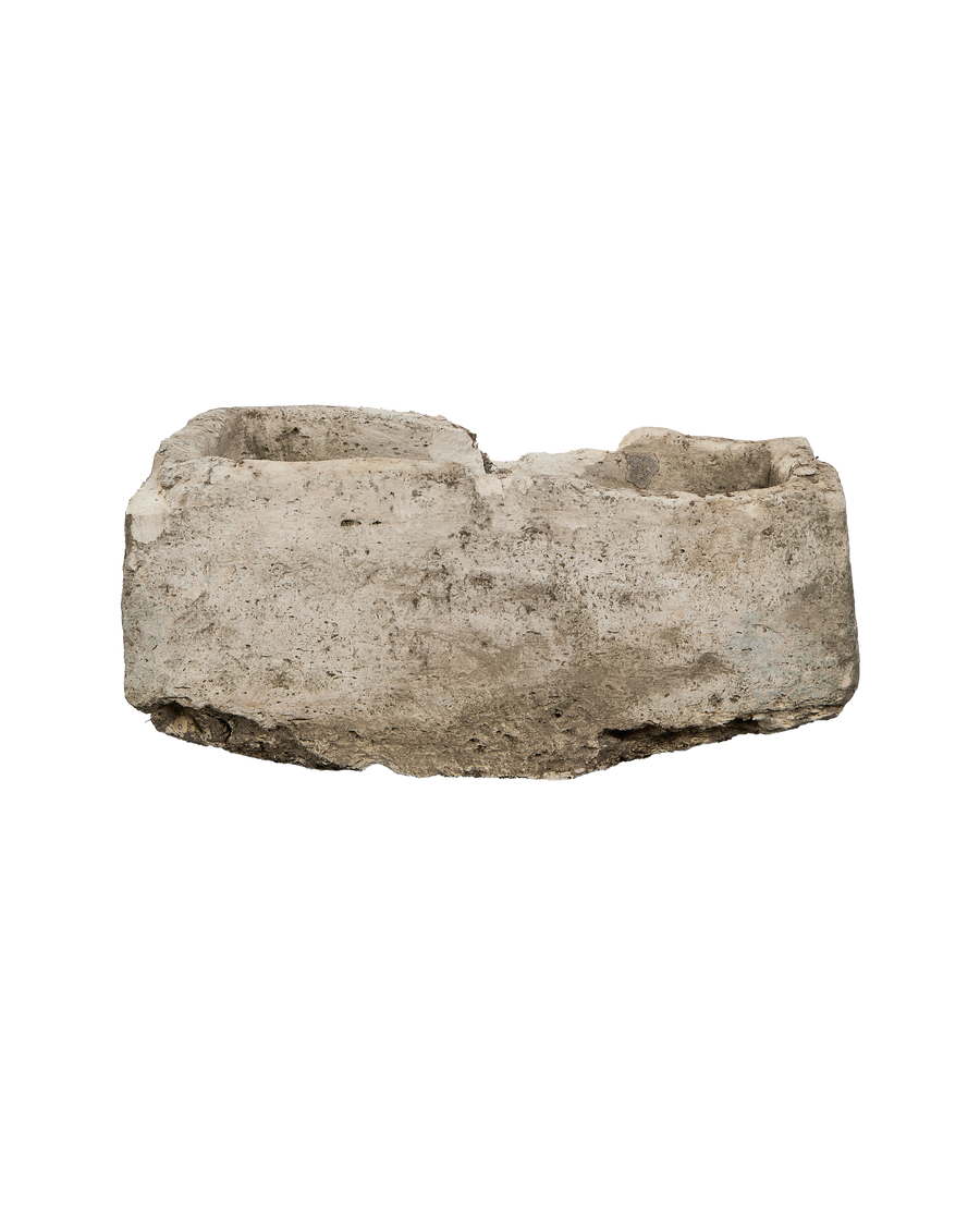 Vintage rectangle limestone trough, showing the rough, weathered texture and varied rim.