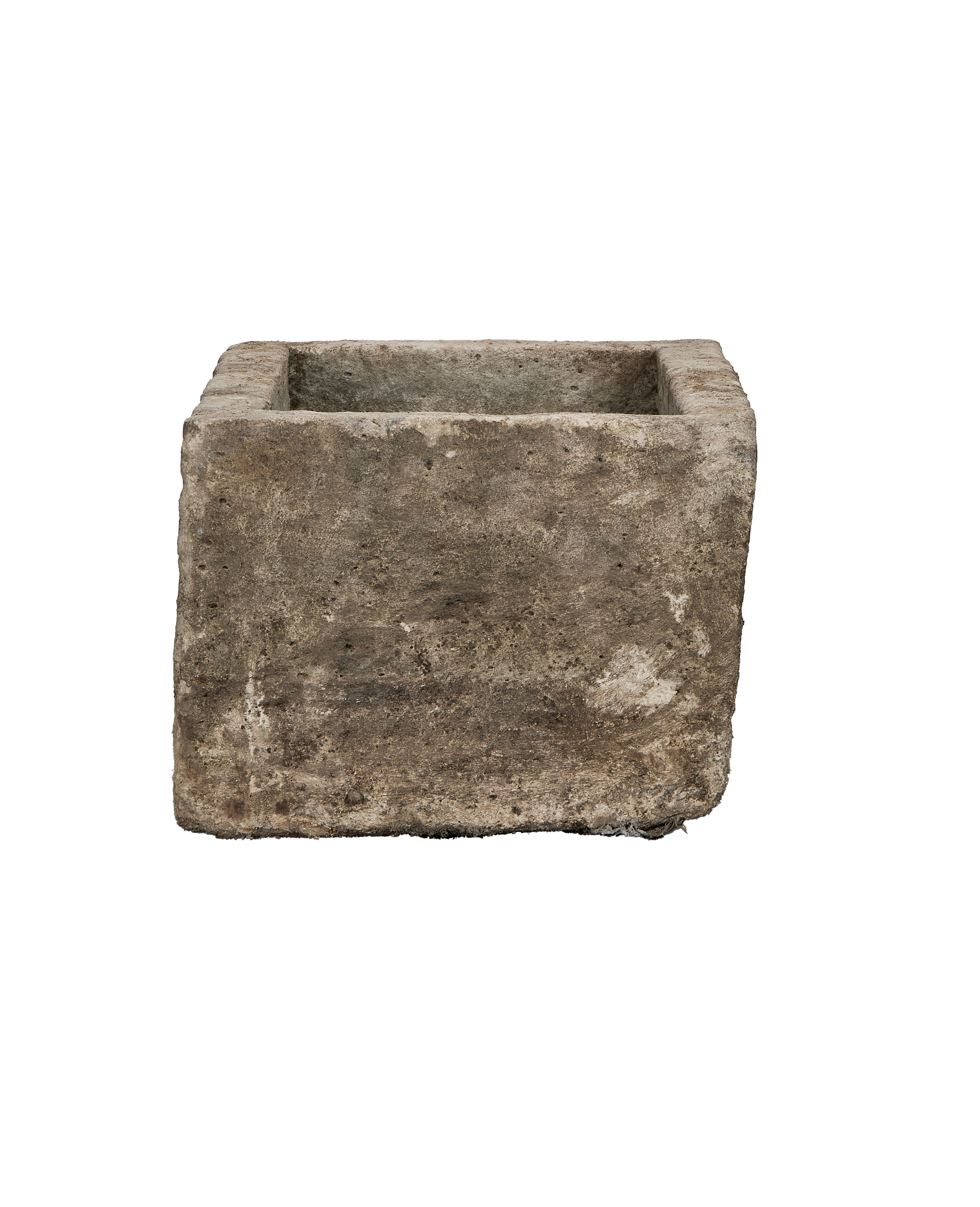 Vintage Indonesian limestone trough, square shape, showing rough, weathered stone texture from side angle.