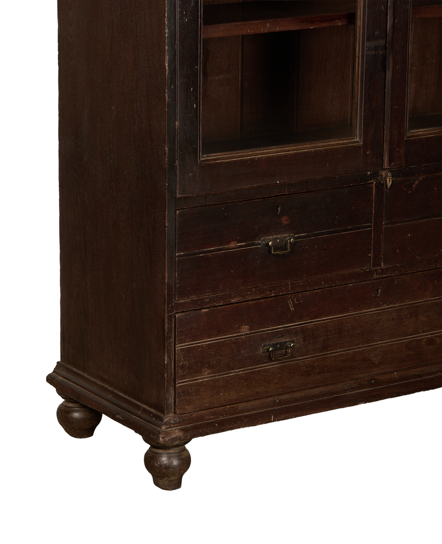 Vintage Indian oak cabinet details: glass-front top, lower drawers, brass pulls, and worn finish.