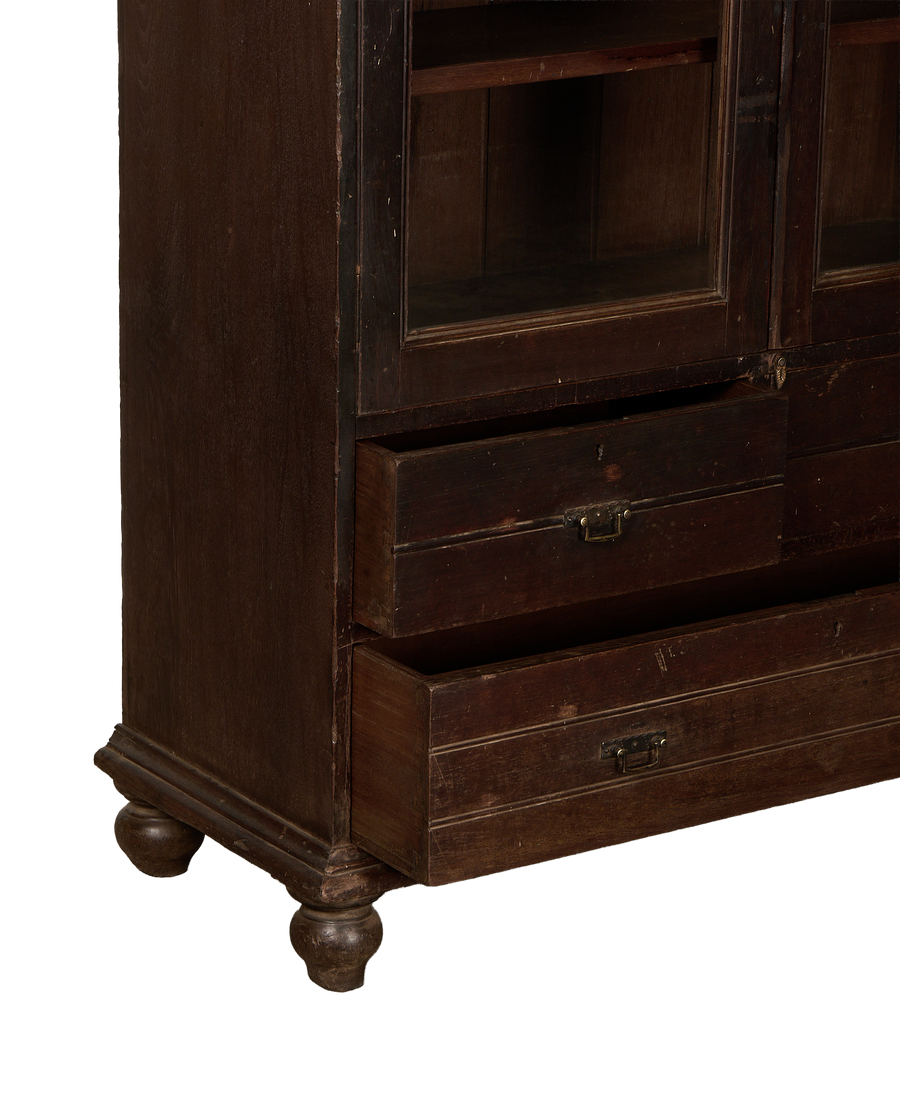 Vintage Indian oak cabinet detail, showcasing open drawers and turned feet, distressed dark wood.