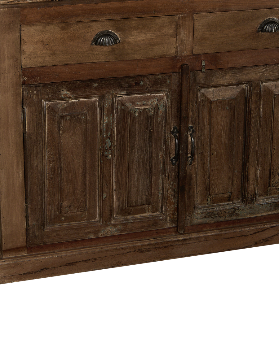 Front detail of vintage Indian oak wood cabinet; distressed doors and drawers with antique metal handles.