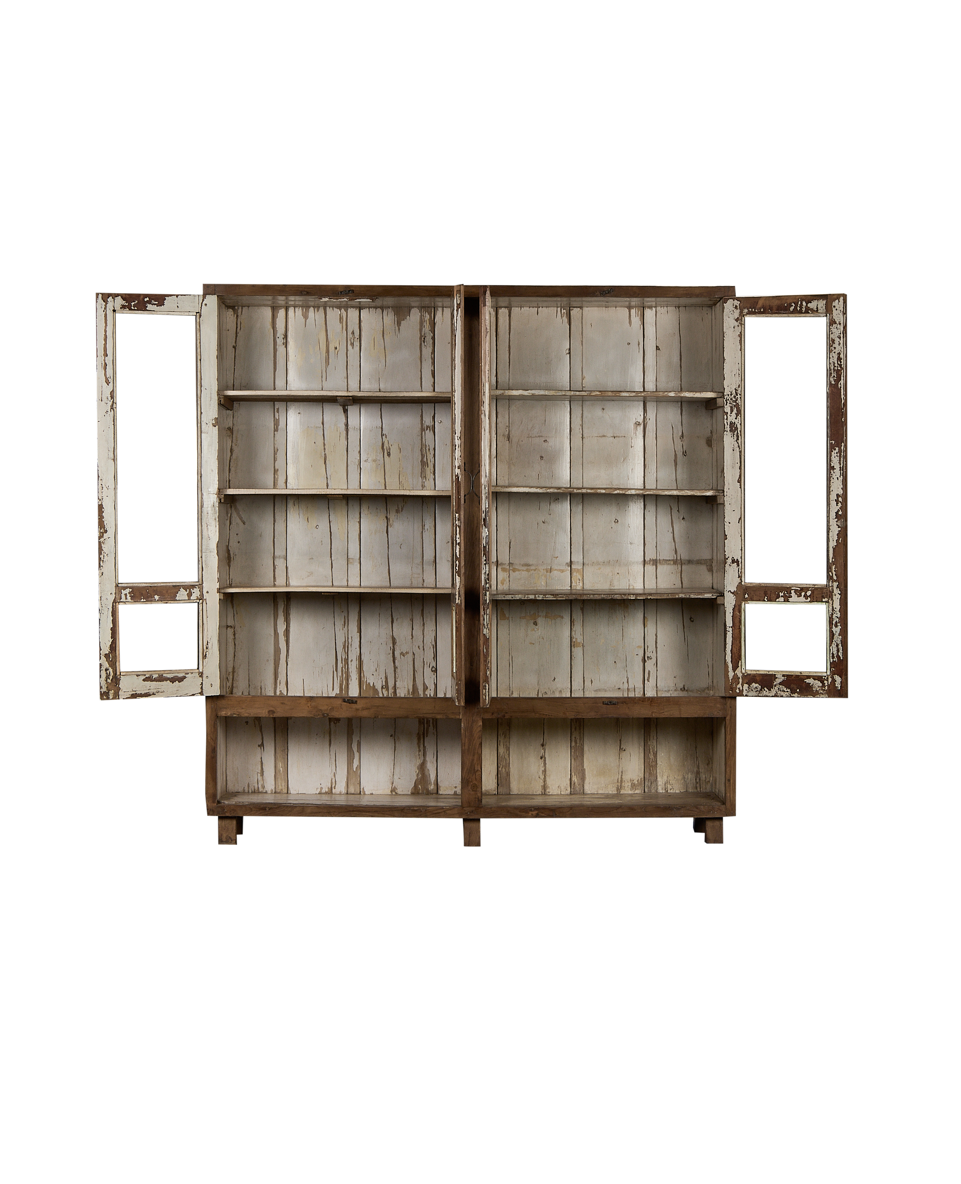Open doors of vintage Indian oak wood cabinet revealing distressed white shelves.