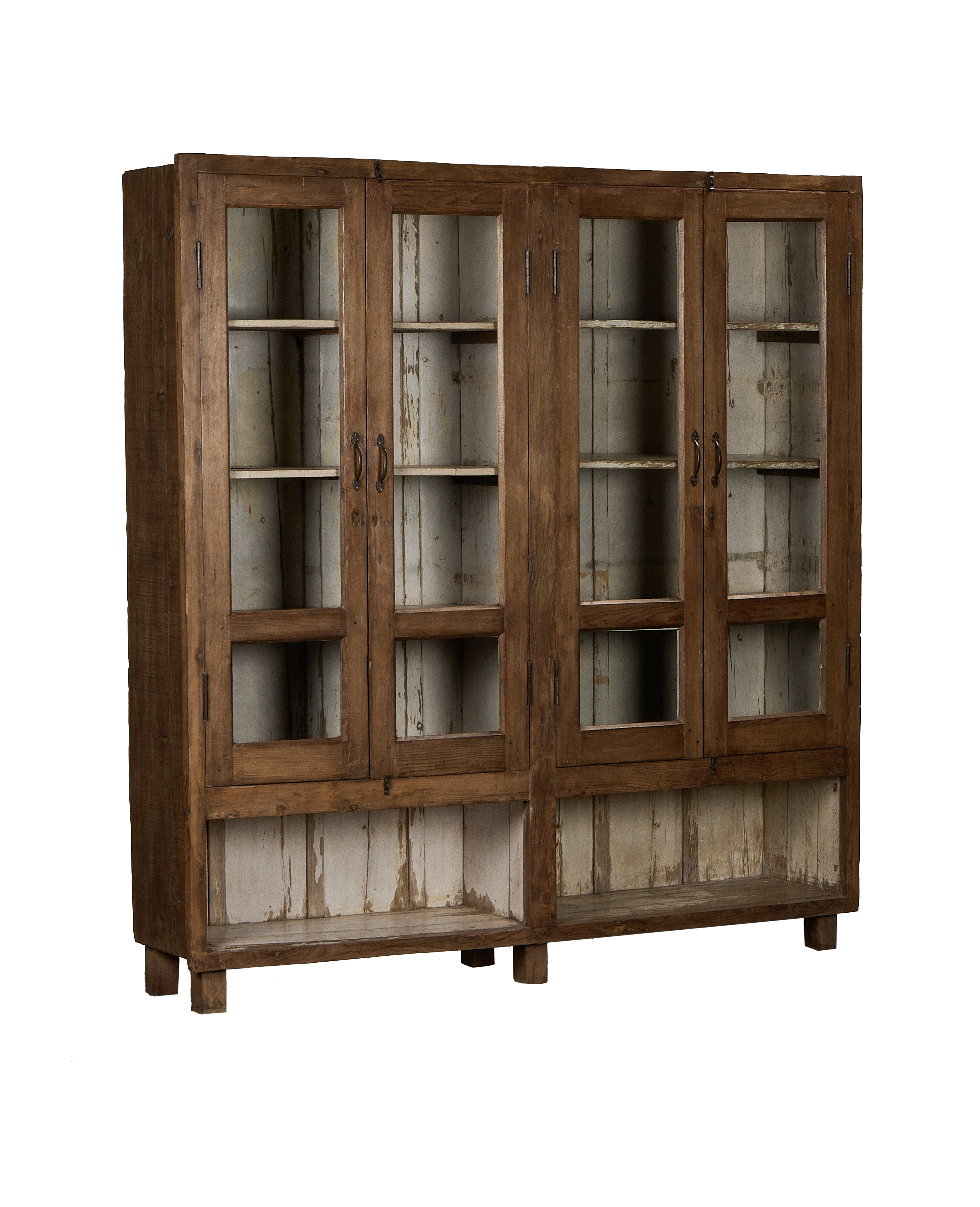 Vintage Indian oak cabinet showing distressed white painted interior and glass display doors.