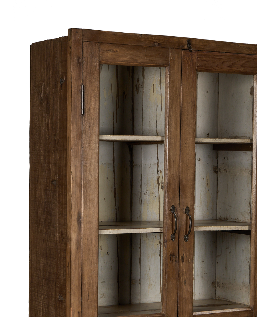 Close-up of vintage Indian oak cabinet's interior shelves and charming aged patina.
