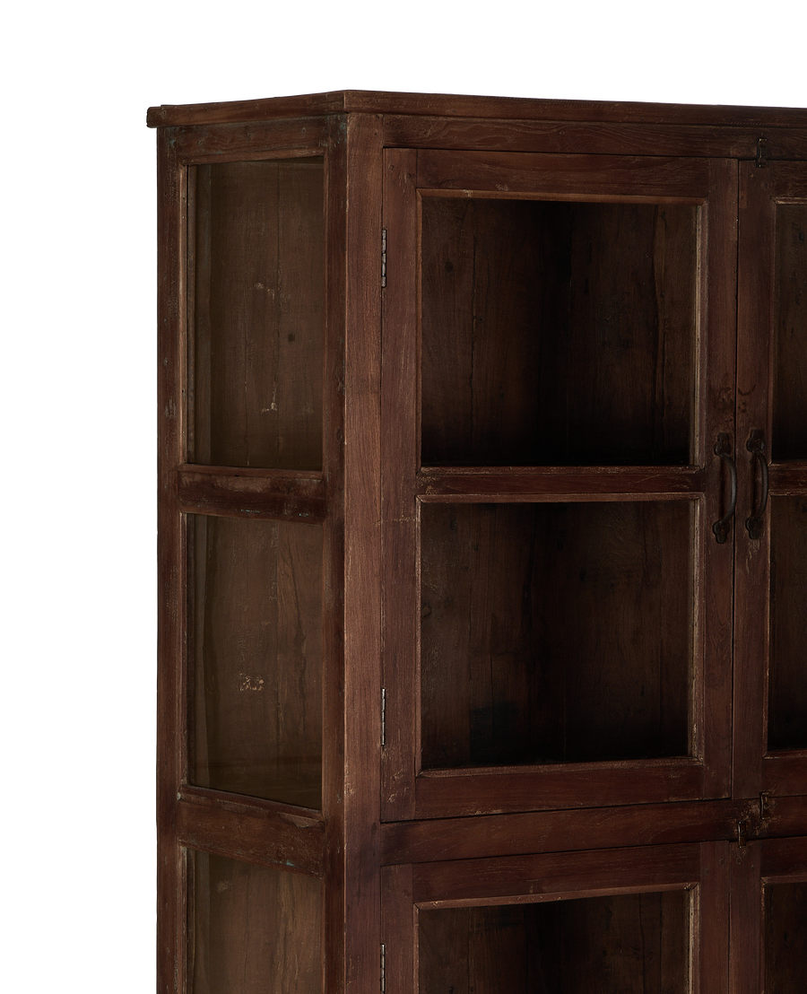 Vintage Indian oak wood cabinet, close-up of glass paneled door and natural distressed finish.