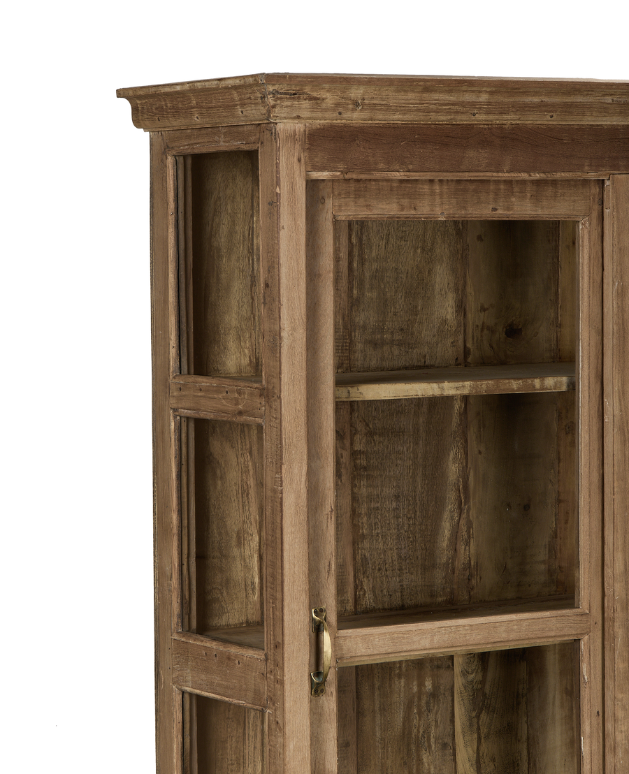 Vintage bleached oak cabinet from India, showing upper glass door panel and brass handle.