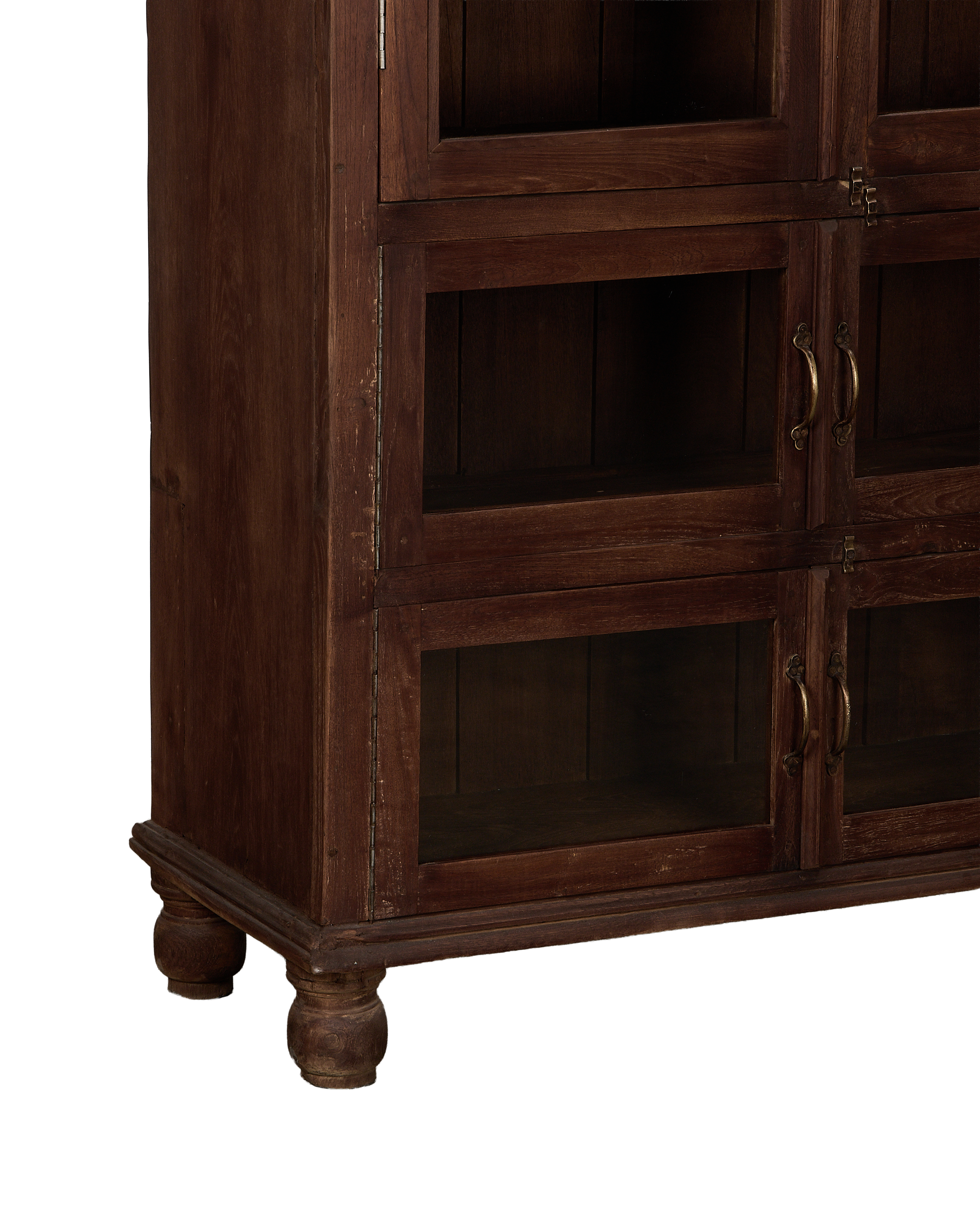 Vintage Indian bleached oak cabinet showing lower section, glass doors, brass handles, and turned feet.