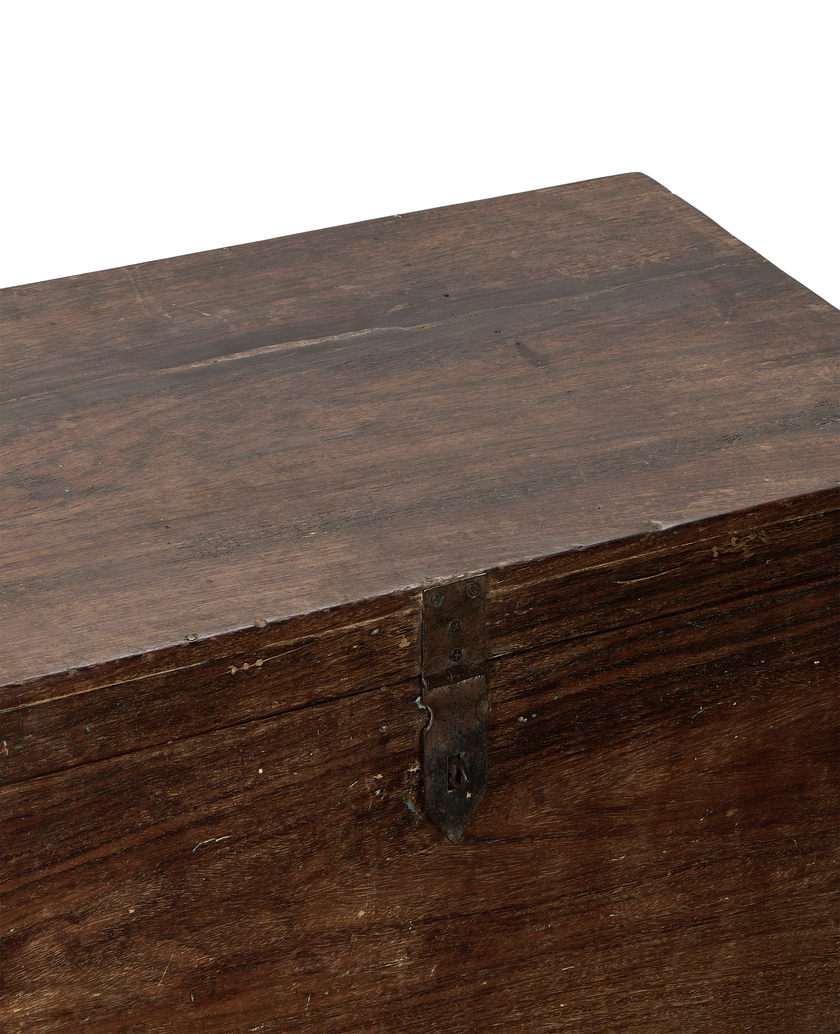 Close-up of vintage Indian oak wood chest lid with rustic metal latch.