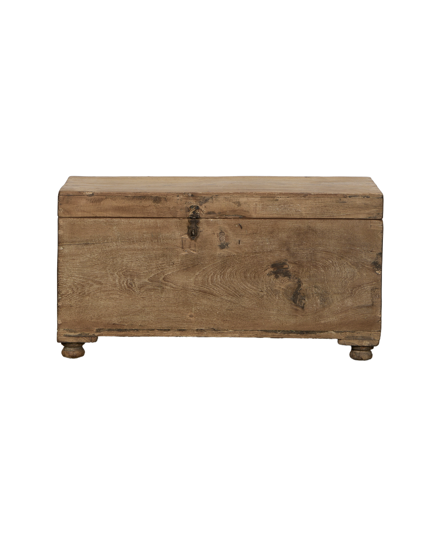 Vintage Indian oak wood chest, front view highlighting metal clasp and turned feet.