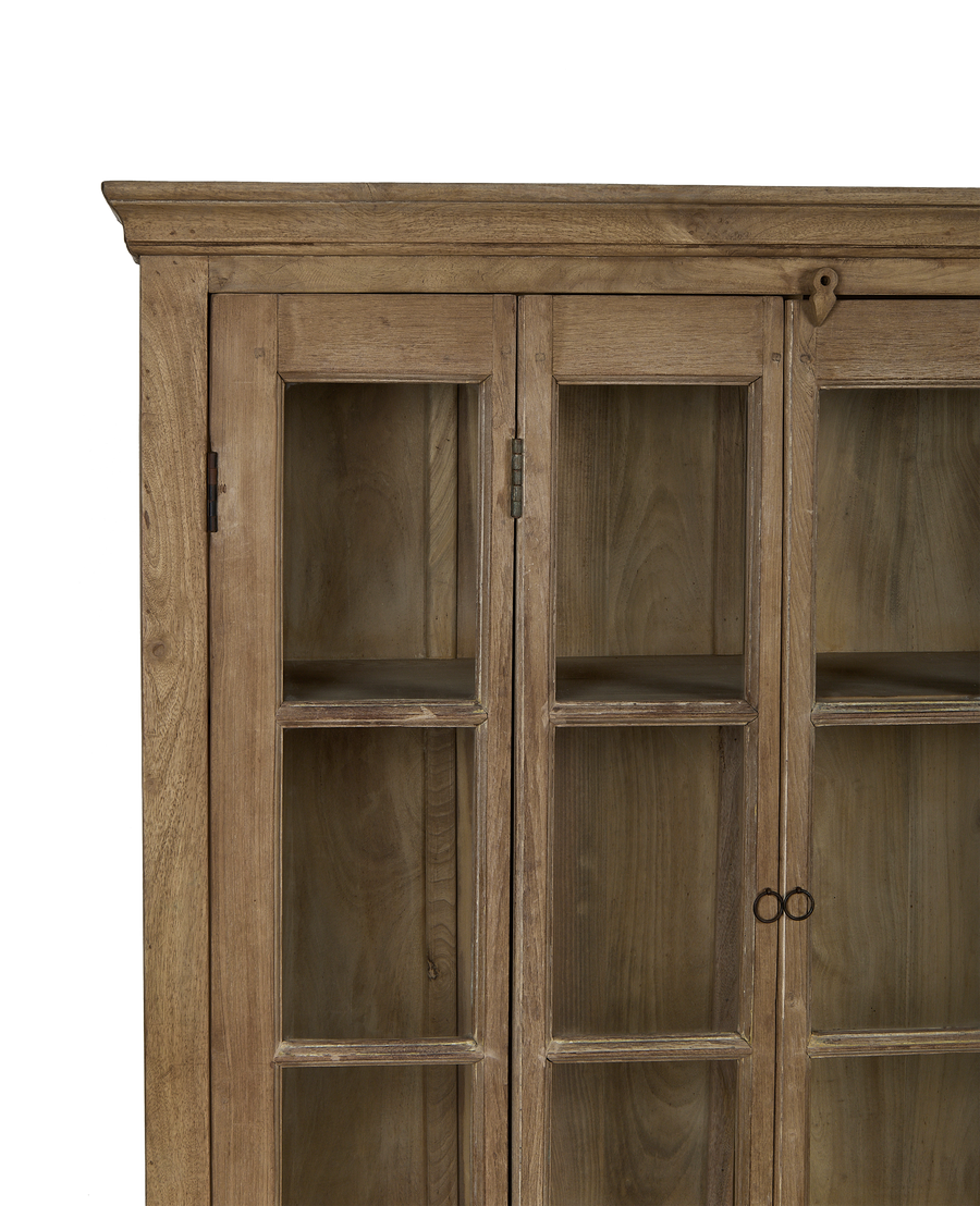 Vintage bleached oak cabinet with glass doors, showing top cornice and latch detail.