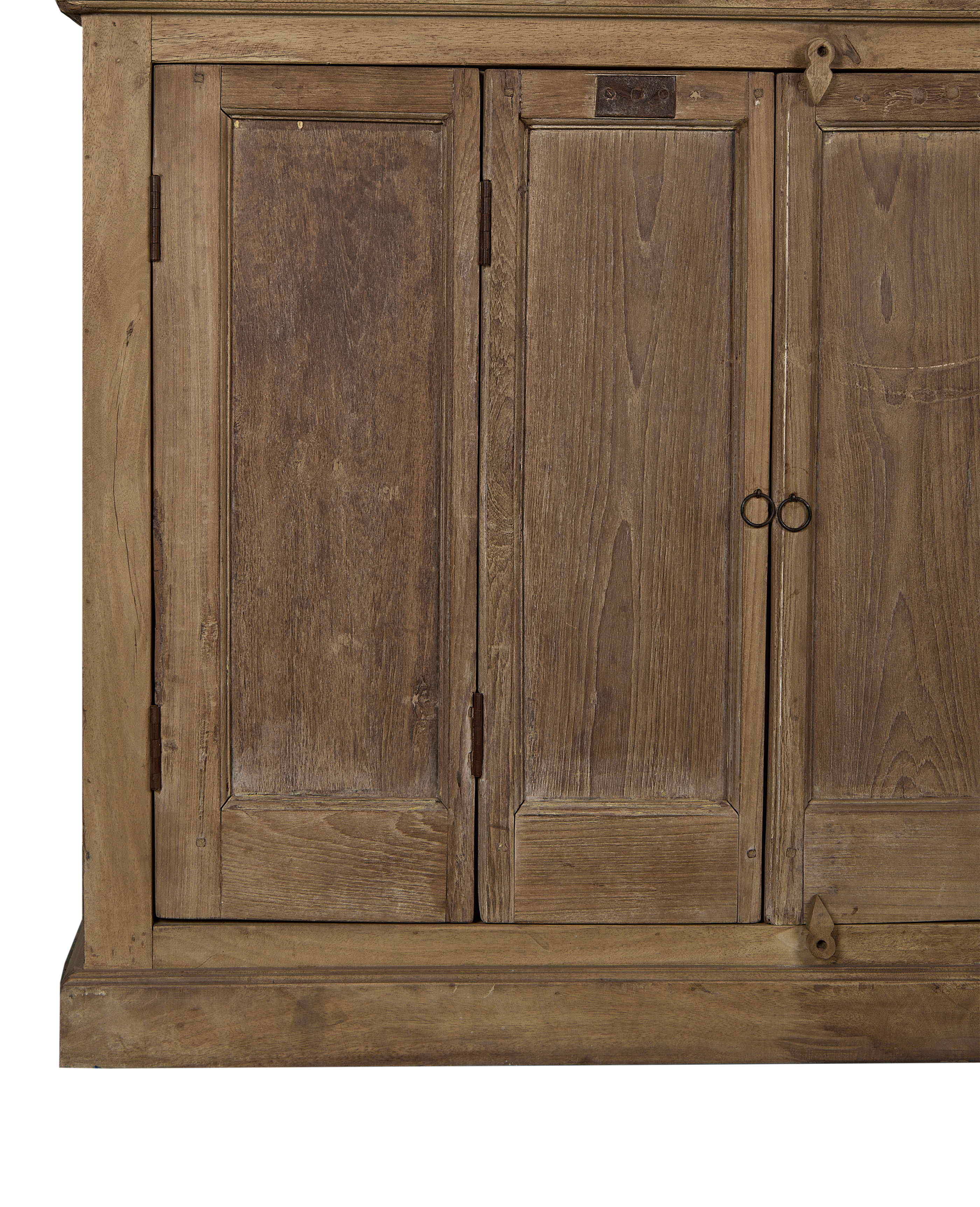 Detail of vintage Indian bleached oak cabinet doors showcasing rustic wood grain and ring pulls.