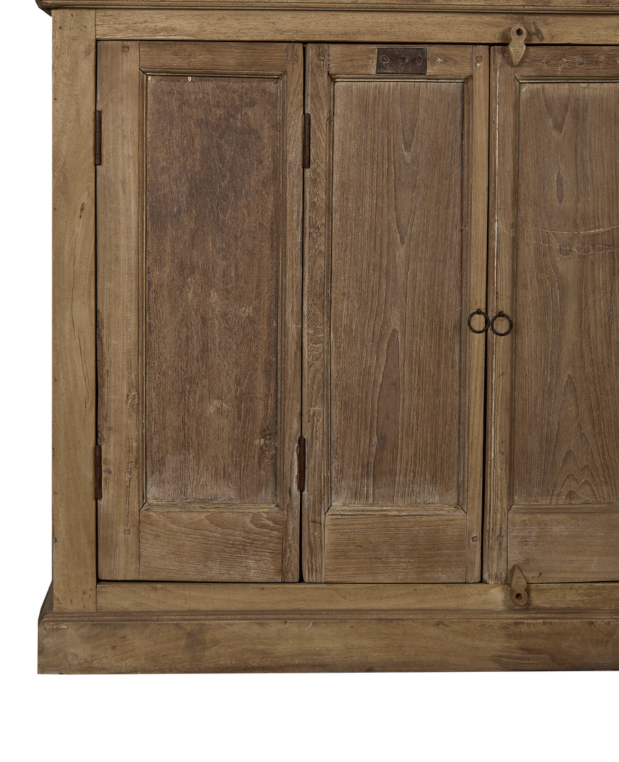 Detail of vintage Indian bleached oak cabinet doors showcasing rustic wood grain and ring pulls.