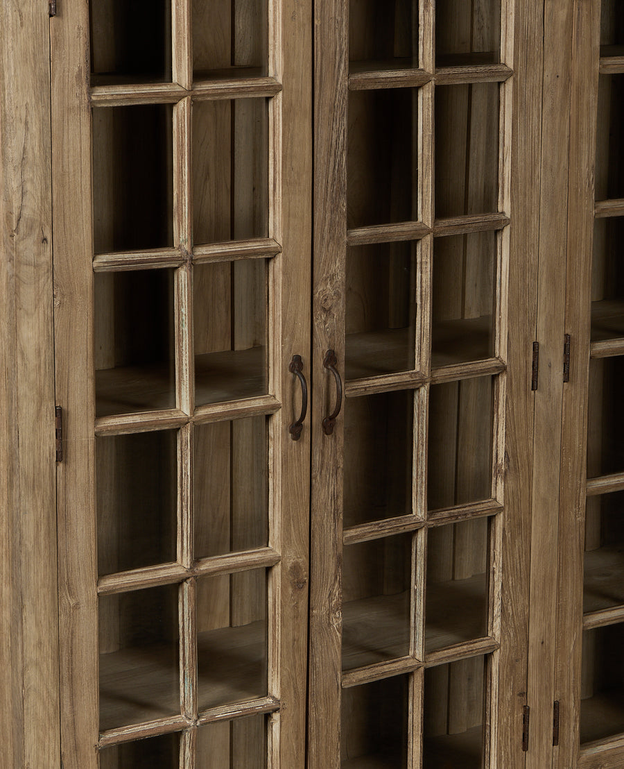 Vintage bleached oak cabinet, India, featuring detailed windowpane glass doors and rustic metal handles.