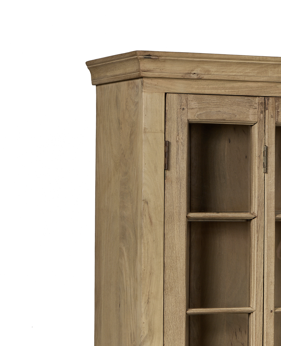 Close-up: Vintage bleached oak India cabinet's top right corner and glass door detail.
