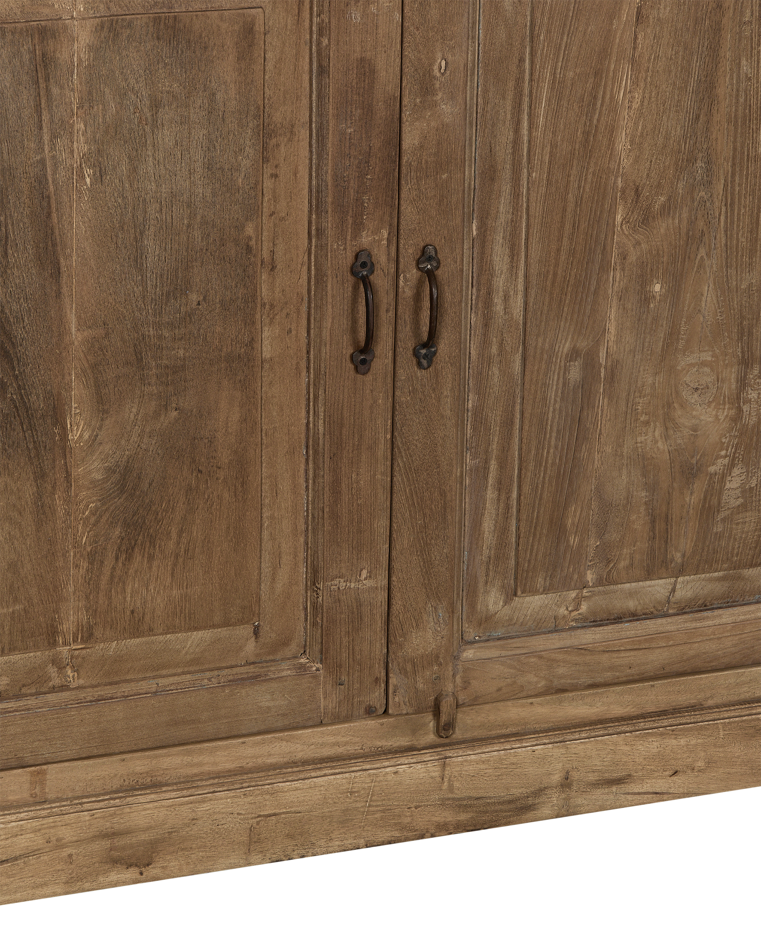 Close-up of vintage Indian bleached oak cabinet doors with aged iron handles.