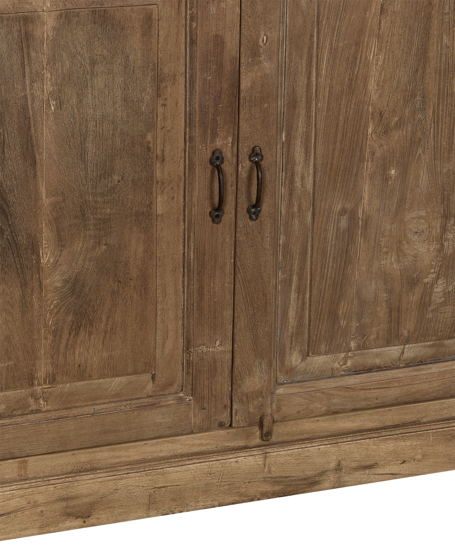 Close-up of vintage Indian bleached oak cabinet doors with aged iron handles.
