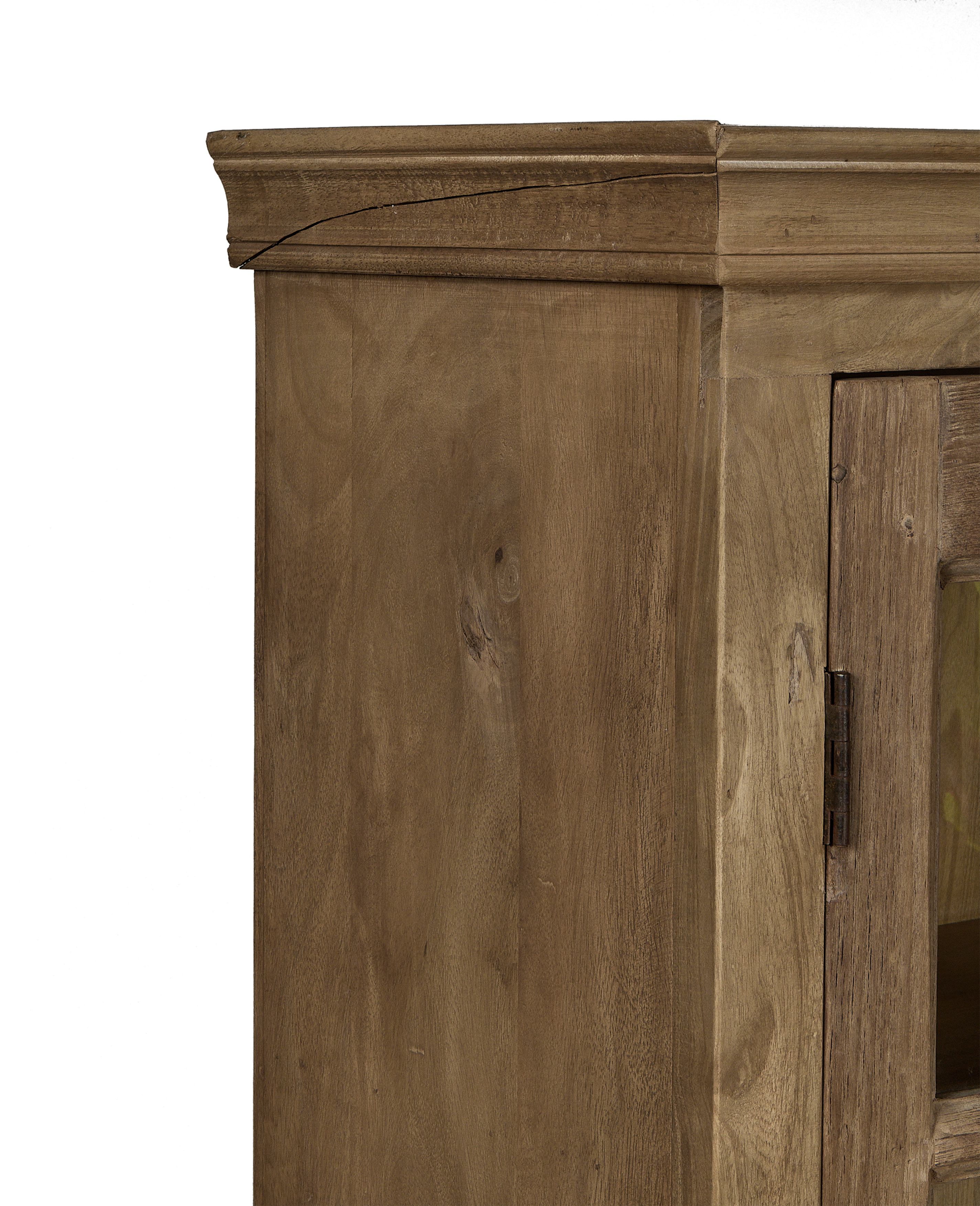 Close-up of top molding detail on vintage bleached oak cabinet from India.