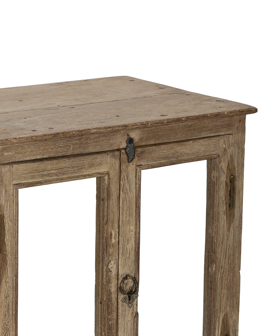 Vintage Indian bleached oak perfume cabinet's front and top, highlighting the aged wood texture, antique hardware, and two bottom doors with ring pull.