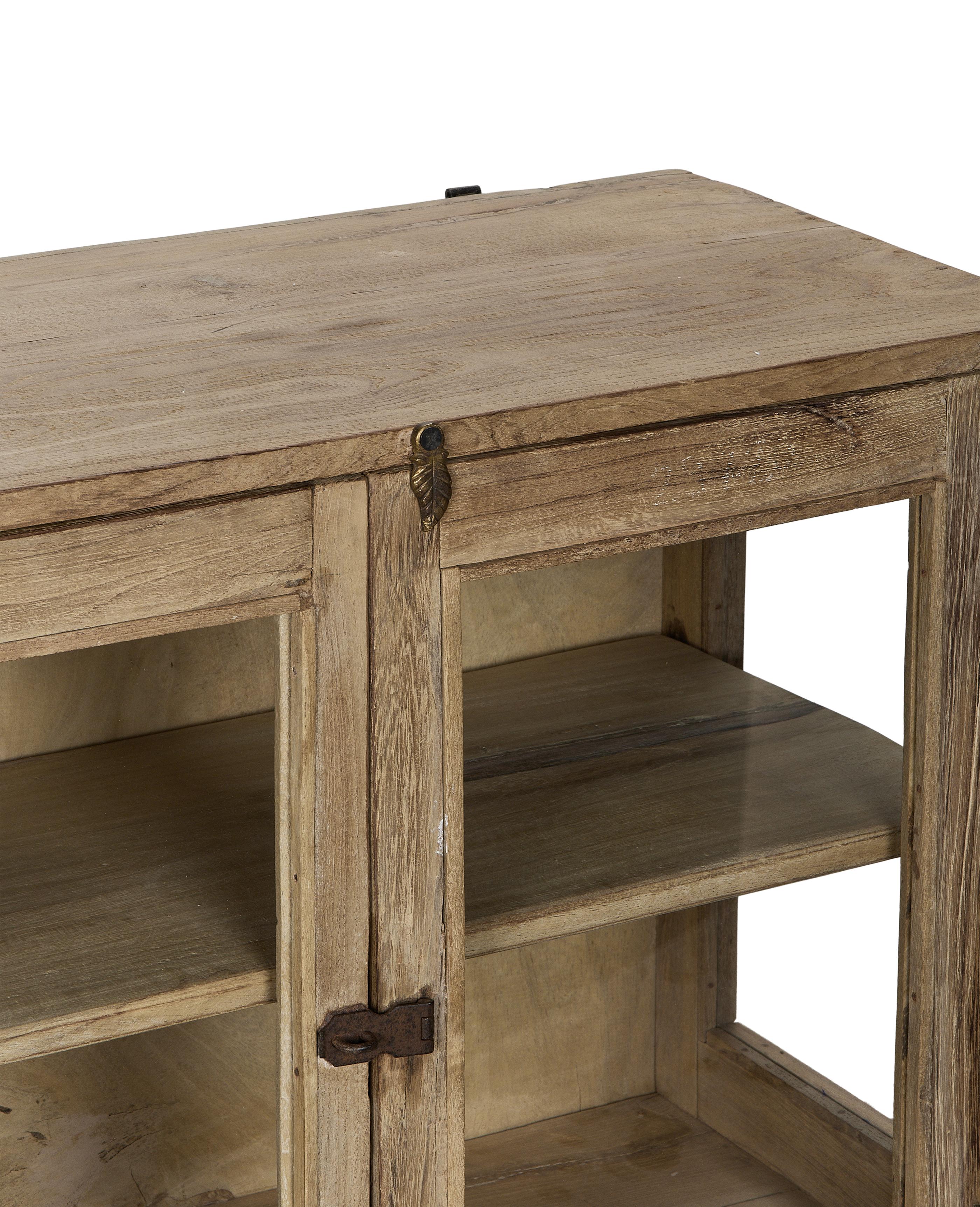 Close-up of vintage Indian bleached oak cabinet's top, rustic leaf latch, and glass shelves.