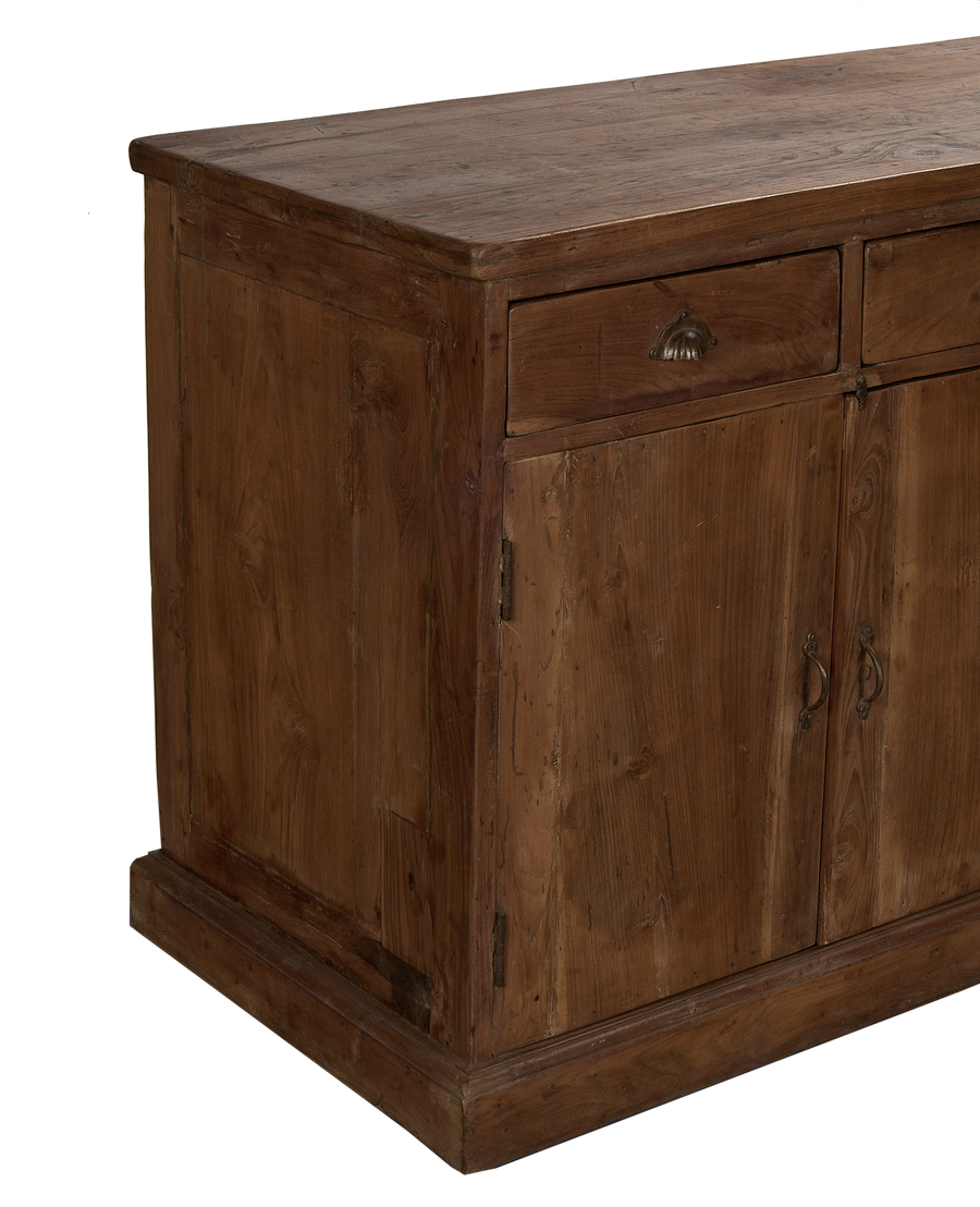 Vintage Indian oak sideboard showing richly textured wood grain, antique brass drawer pull, and detailed base.