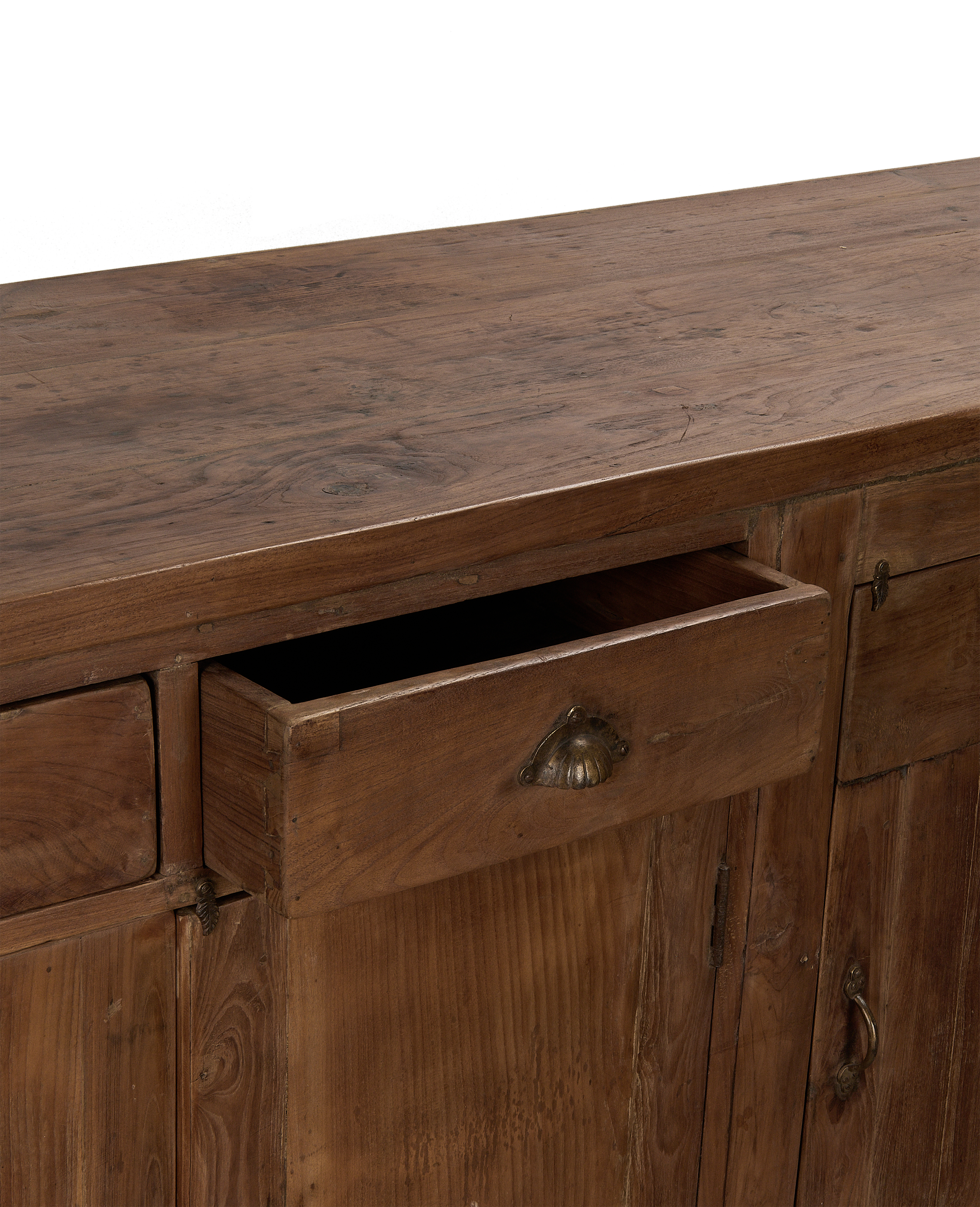 Open drawer of vintage oak sideboard from India, showing natural wood grain detail.