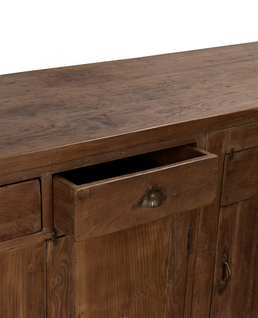 Open drawer of vintage oak sideboard from India, showing natural wood grain detail.