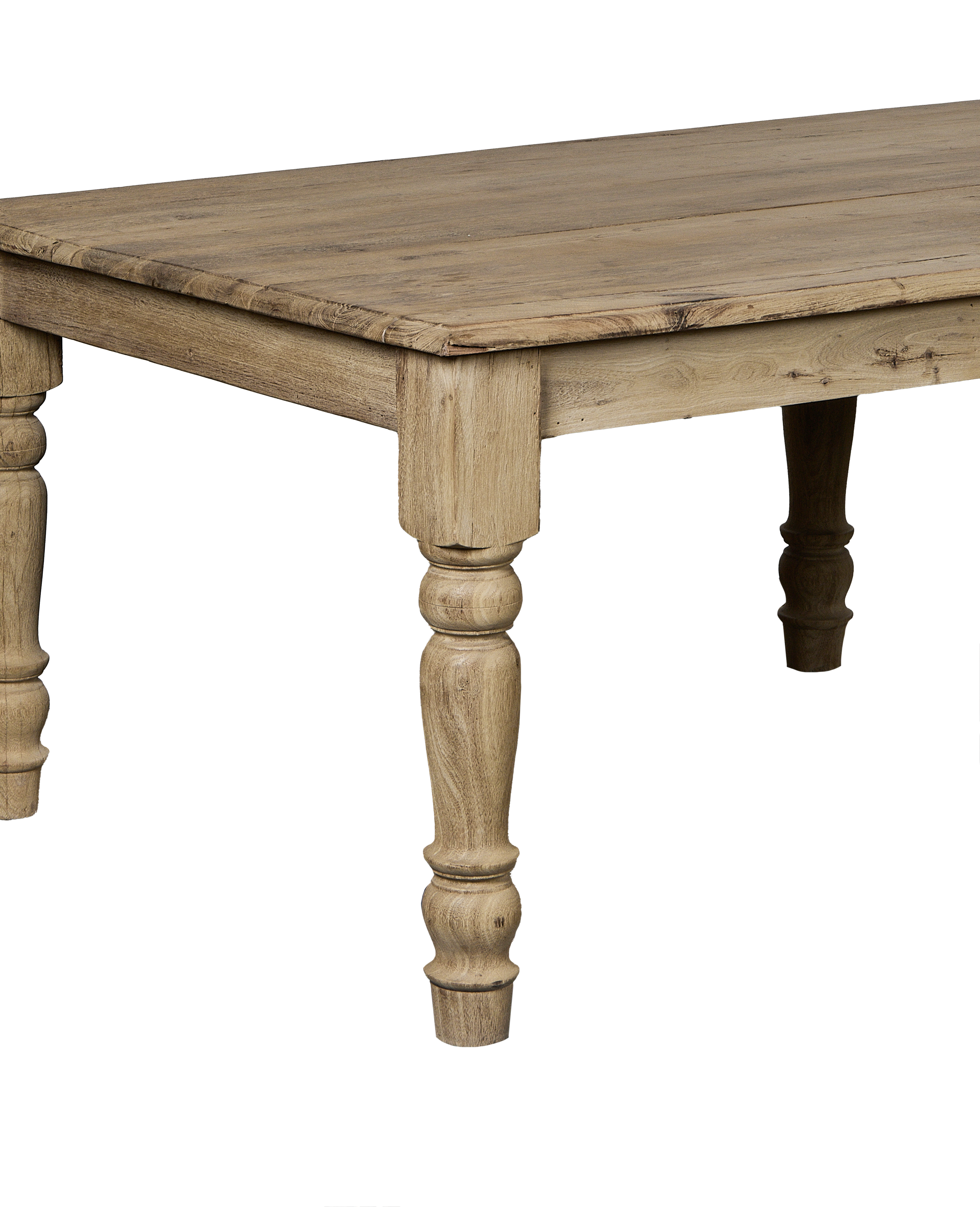 Bleached oak vintage Indian dining table corner view, showing distressed wood grain and carved leg detail.