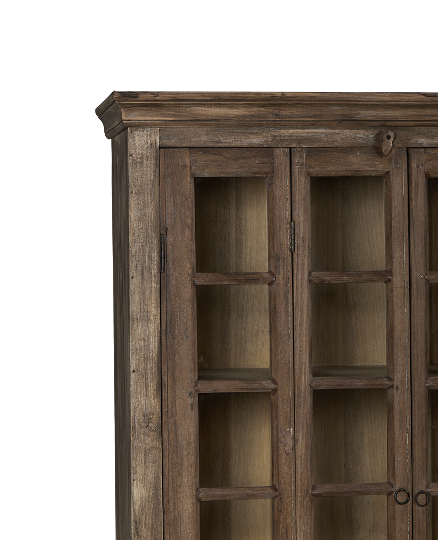 Vintage bleached oak India cabinet's top detail with visible grain and glass doors.