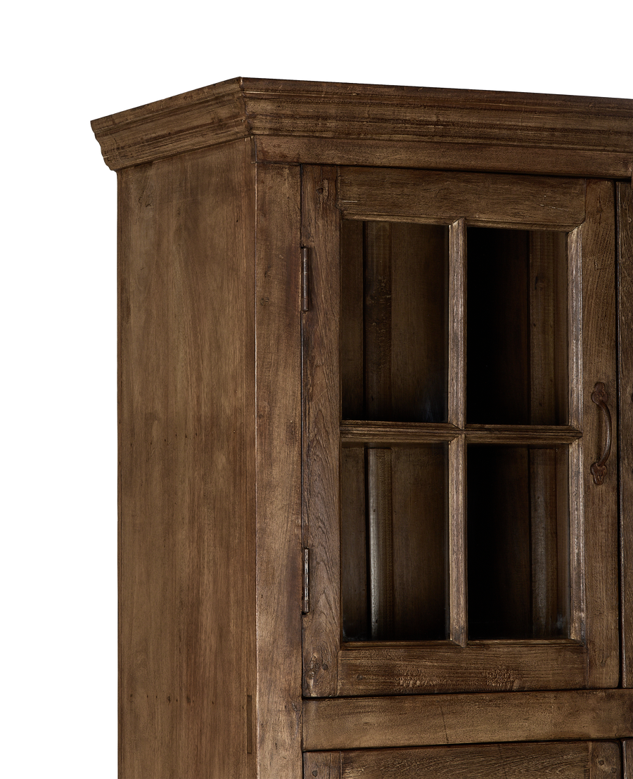Vintage bleached oak cabinet, India, showing intricate door detail, glass pane, and weathered wood.
