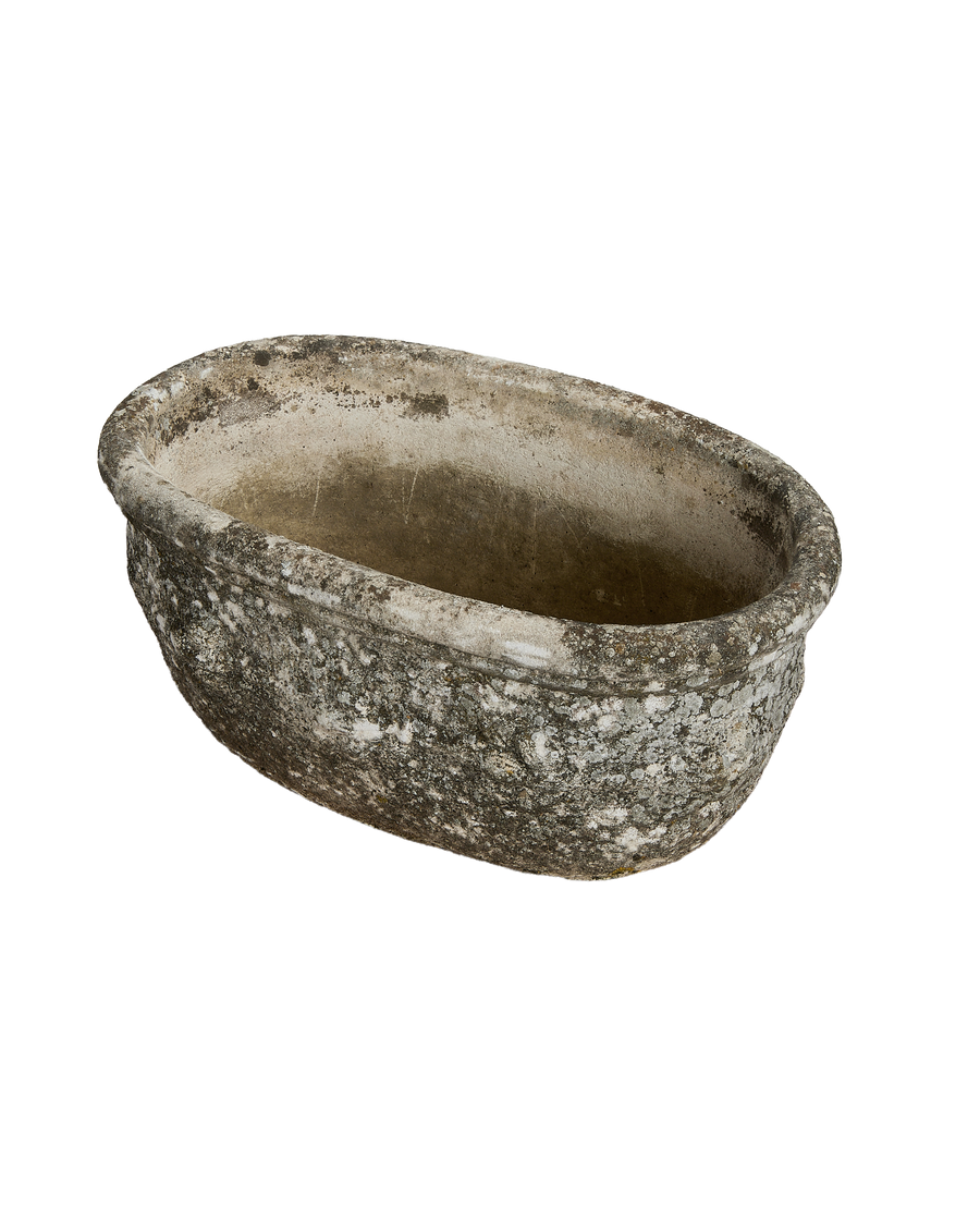 Vintage French oval planter showing weathered concrete texture, lichen, and rounded lip detail.
