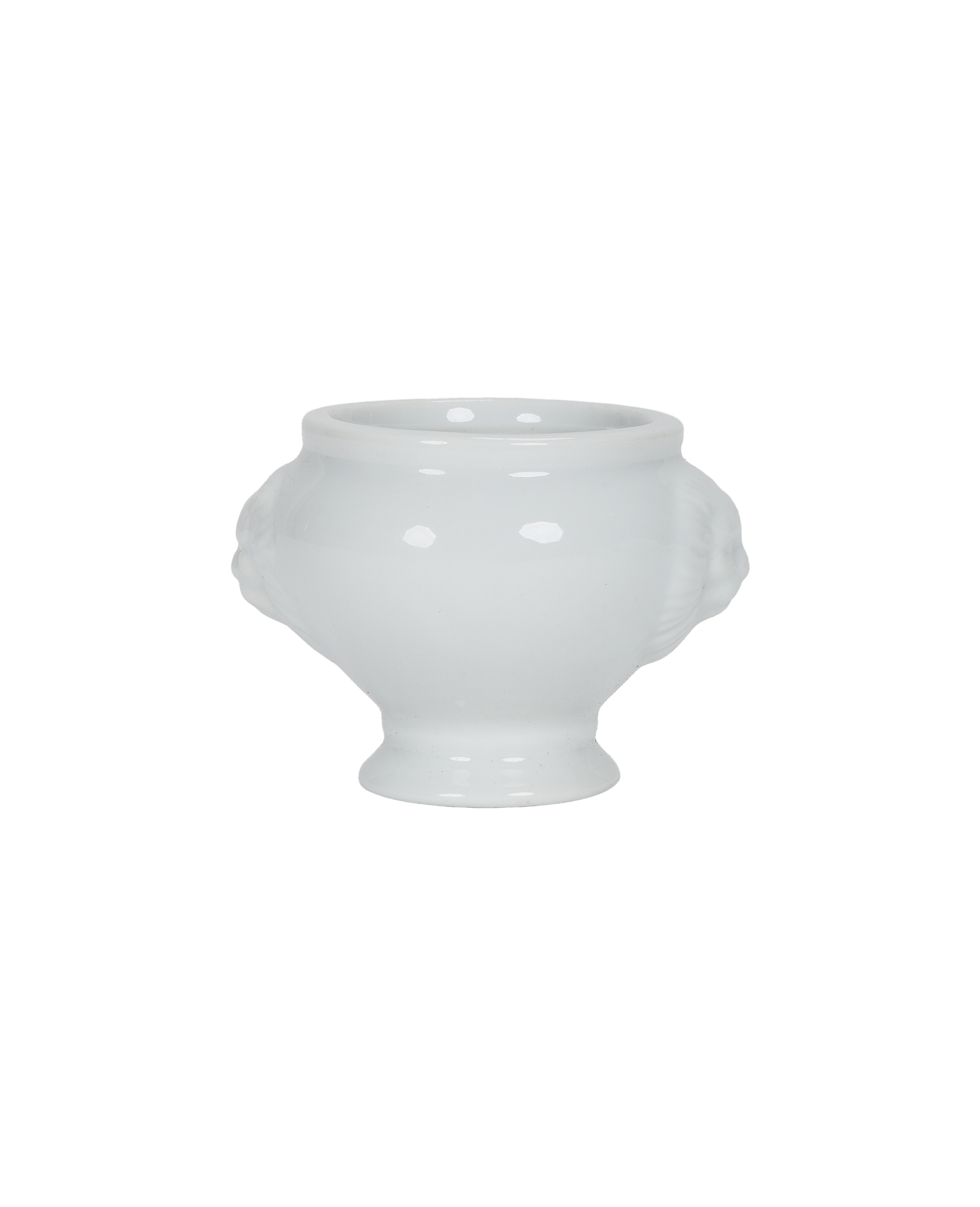 Vintage French milk glass lion-head salt cellar, featuring recessed carvings for design.